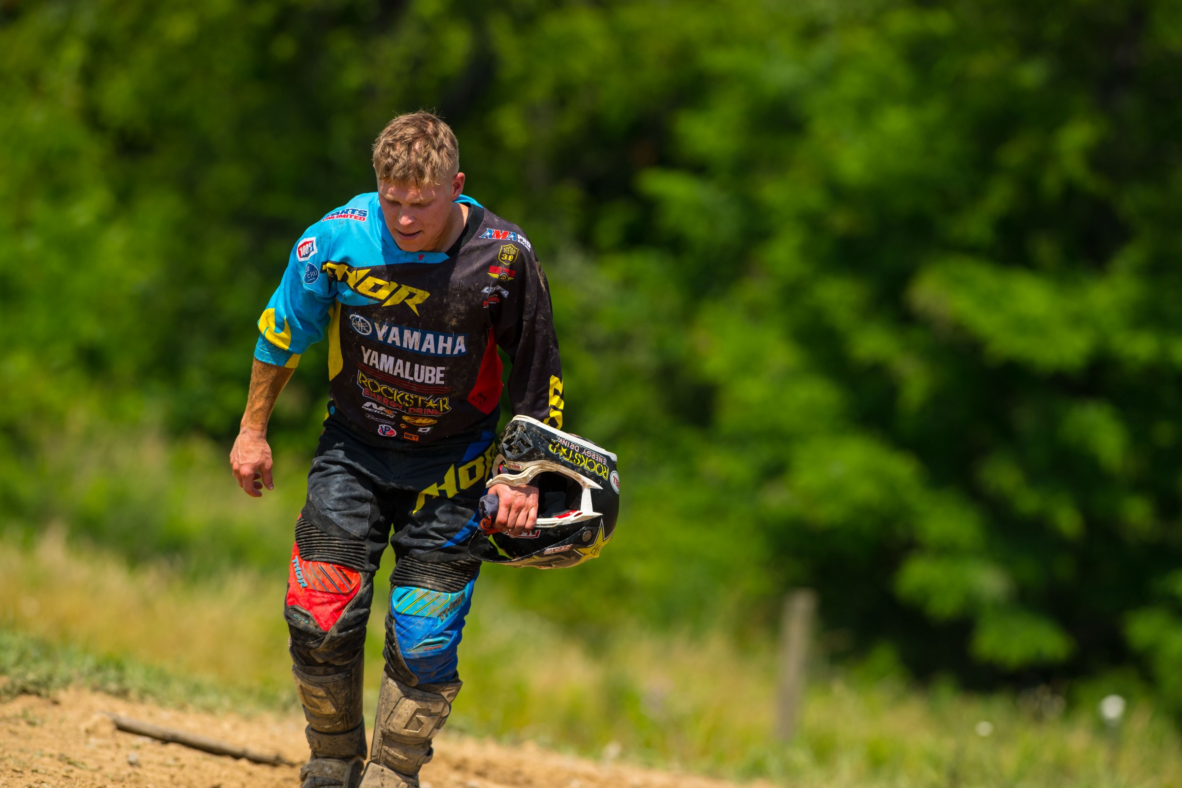 Alex takes the long walk back to the pits after his bike failed in the first moto.