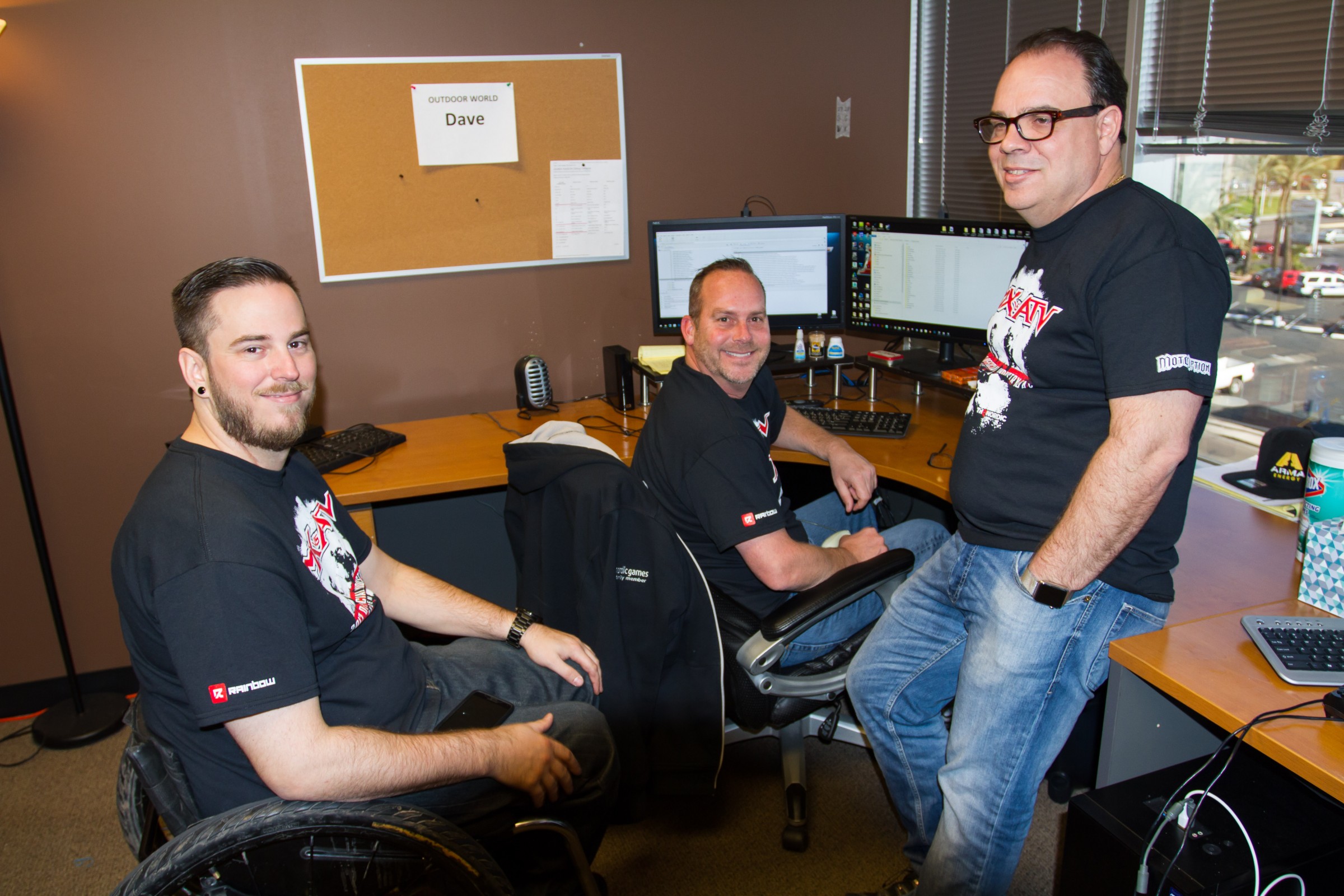 Left to right: Lead Game Designer Mike Mamula, Sr. Track Designer Dave Dwire, and Ken do some virtual bench racing