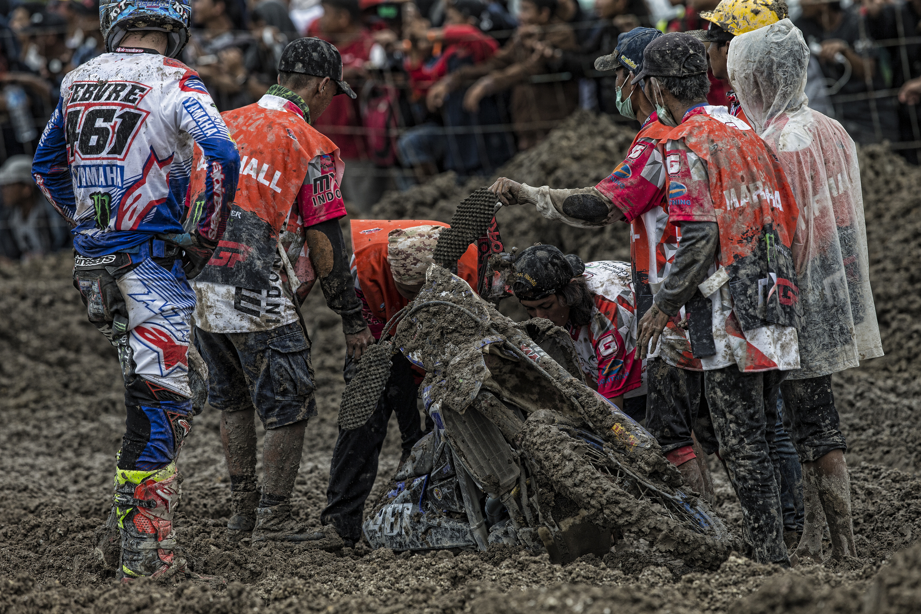 Febvre and crew attempt to get his bike out of the mud.
