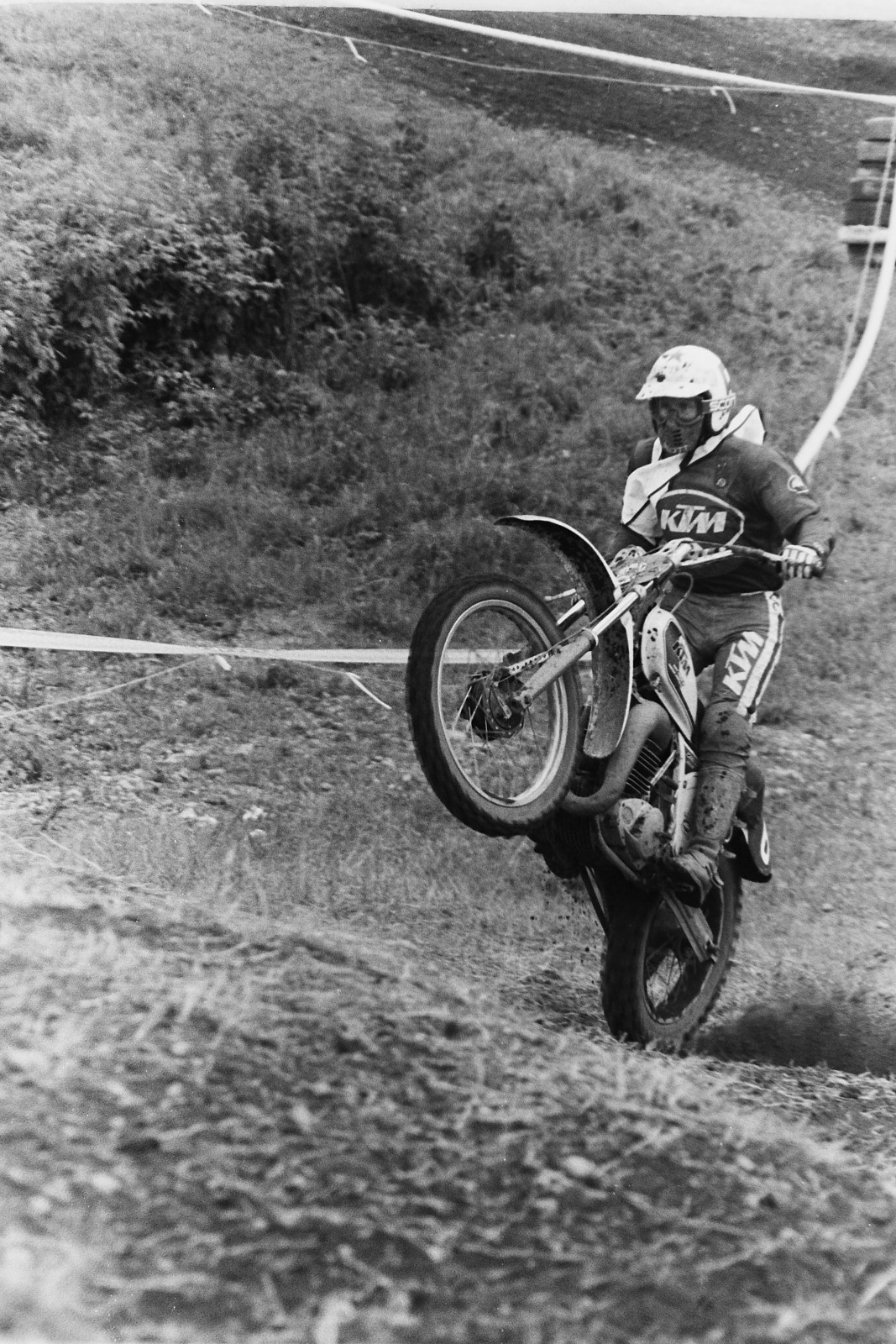 Soviet rider Vladimir Kavinov (6) wheelies his white KTM over some Unadilla bumps.