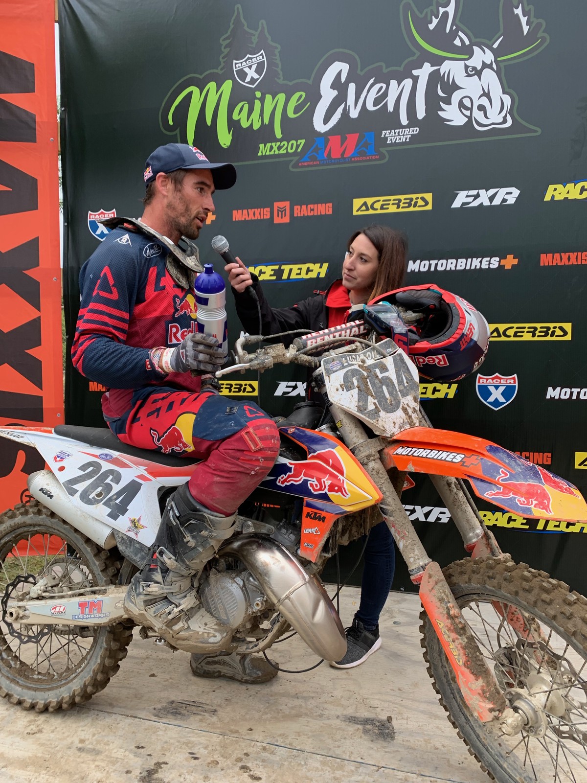 Sipes doing a post-race interview on the podium with Brooke Stewart, Ronnie Stewart's wife.