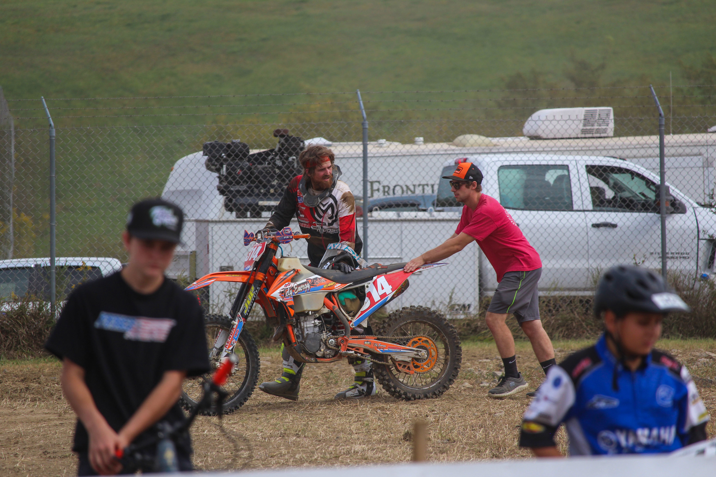 Grant Baylor pushing his bike back to the pits.