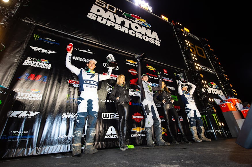 The Daytona Supercross 250SX main event podium: Chase Sexton (second), Garrett Marchbanks (first), and Jeremy Martin (third).