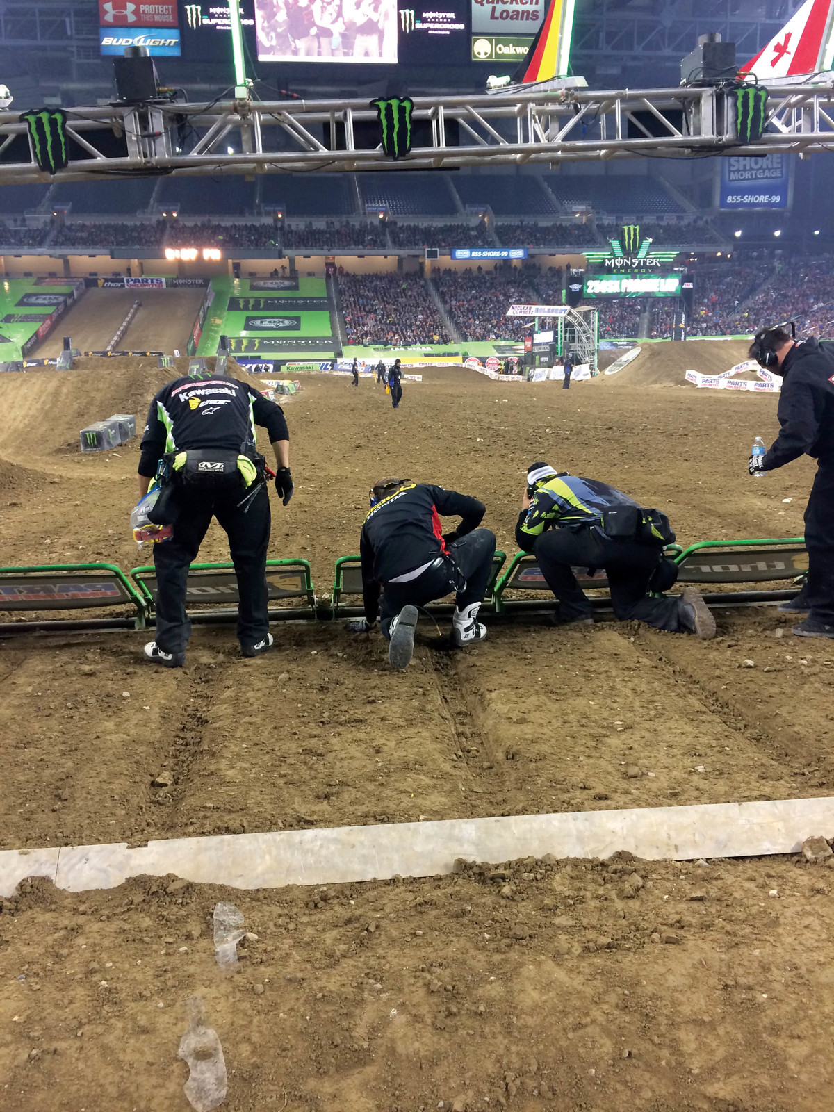 Mechanics make a few adjustments while their riders are on the parade lap.
