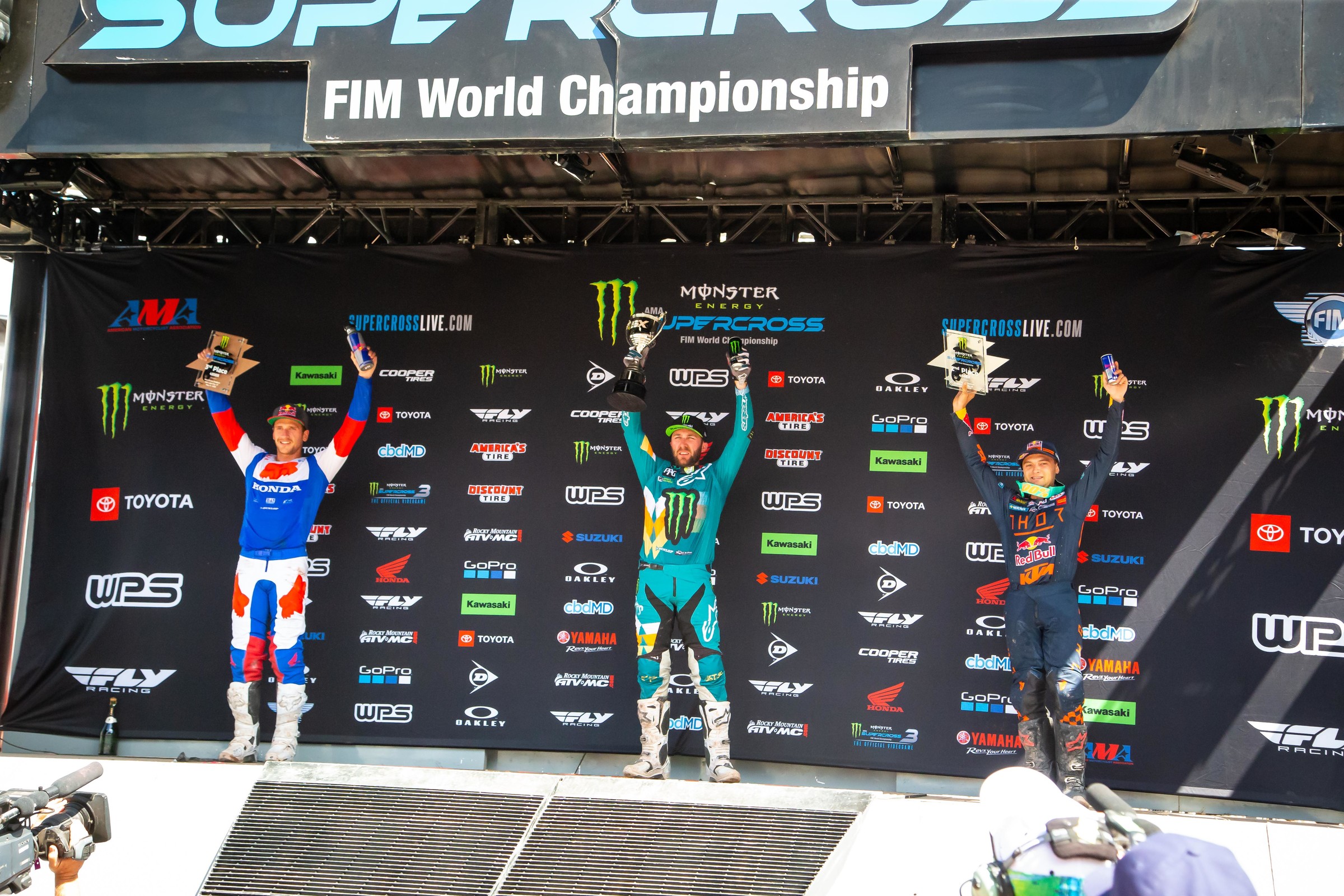 The Salt Lake City 1 Supercross 450SX main event podium: Eli Tomac (first), Cooper Webb (second), and Ken Roczen (third).