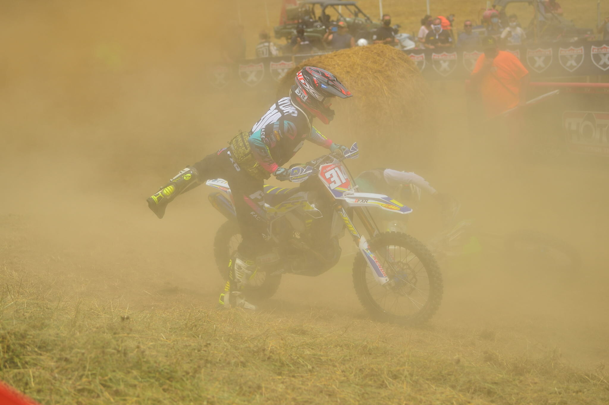 Grant Baylor remounting after a crash in the second turn.