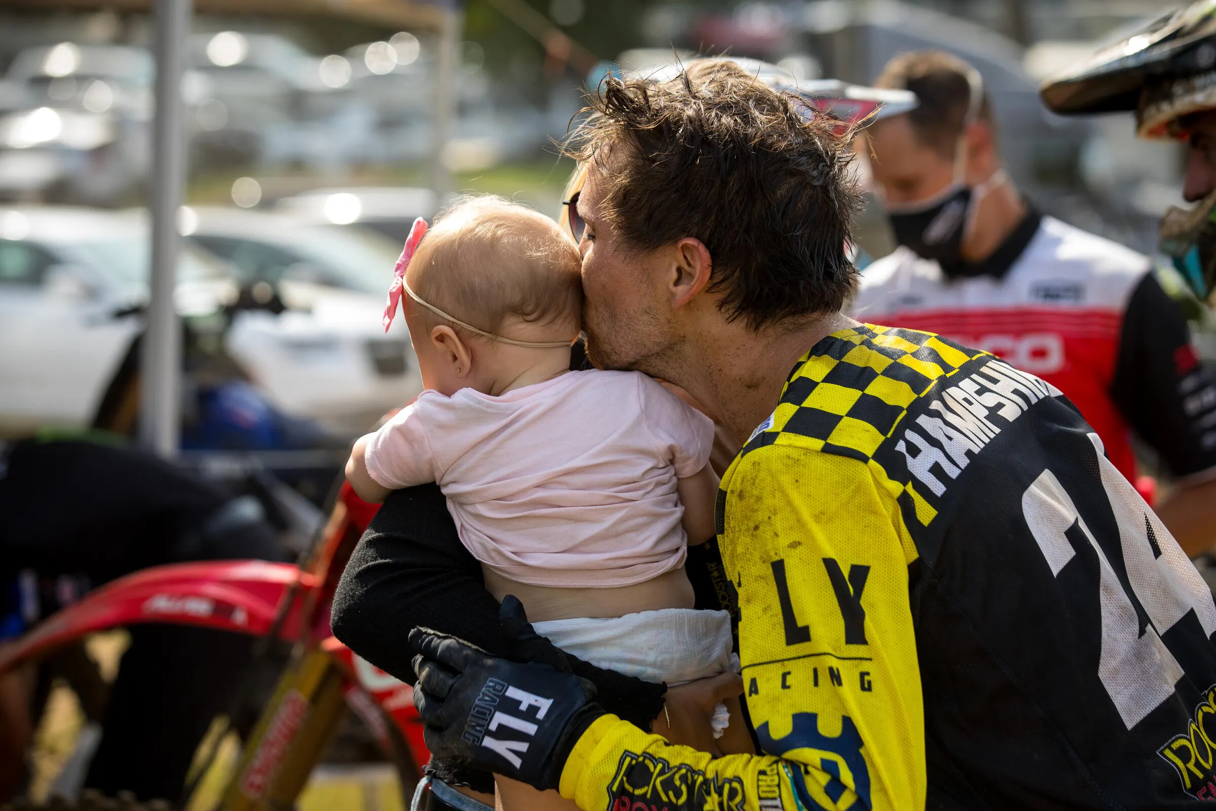 RJ celebrates his overall win with a kiss to his daughter Ivy.