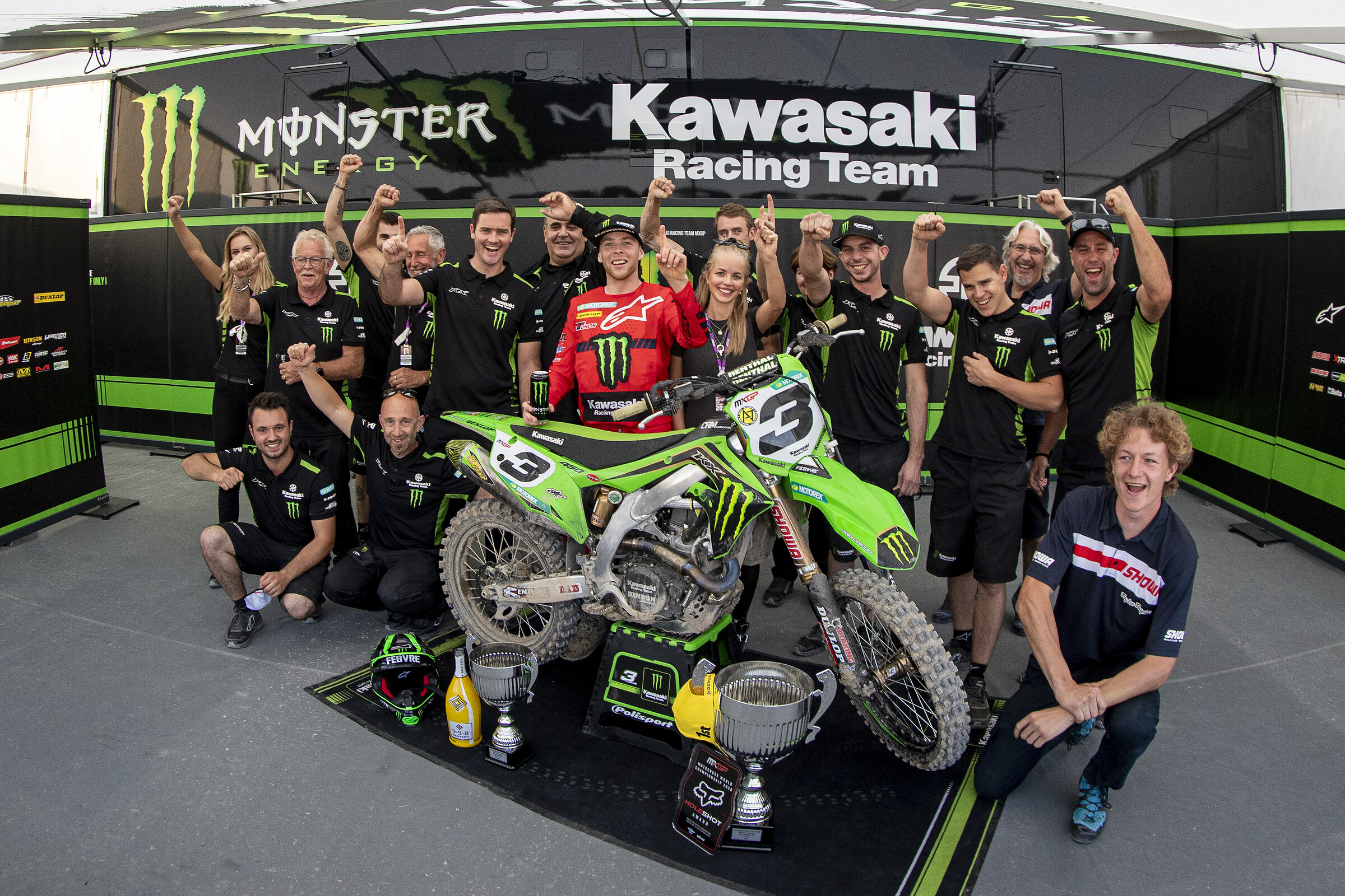 The Kawasaki Racing Team celebrates Febvre's victory with the team.