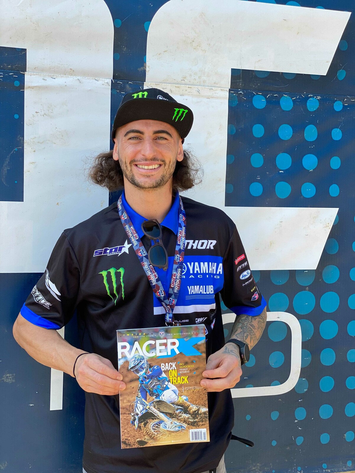 Dylan Ferrandis holding the November 2020 issue of Racer X magazine before the 2020 Pro Motocross finale.
