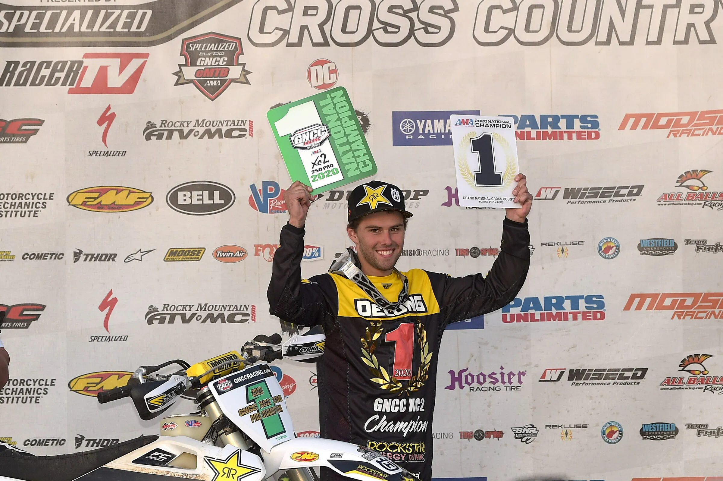 Craig Delong hoisting the 2020 XC2 class #1 AMA plate.