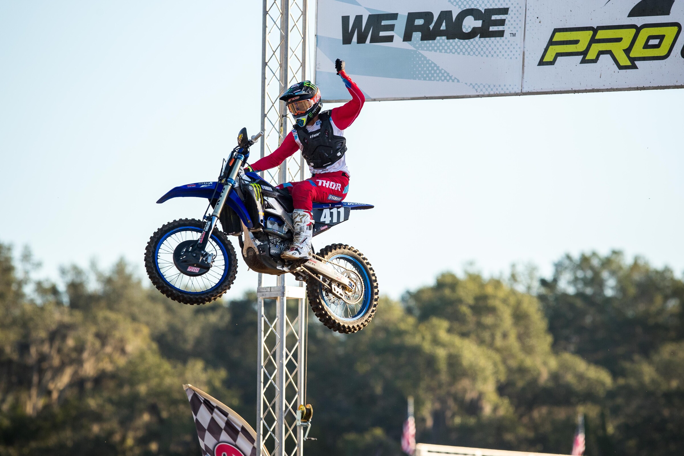 Nick Romano taking a supercross checkered flag.