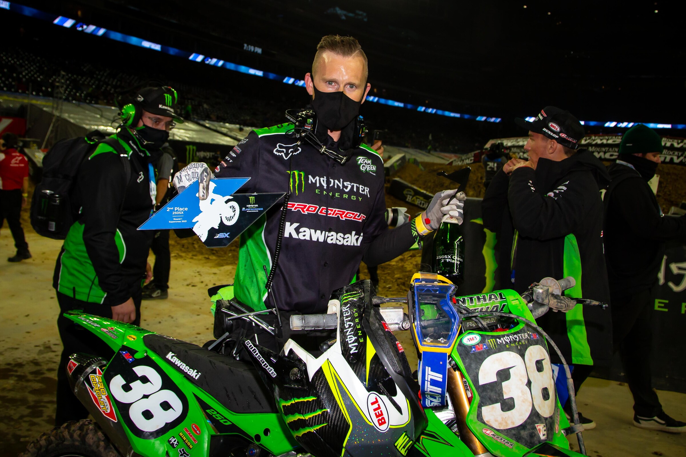 Forkner's mechanic Olly Stone with his rider's podium hardware.