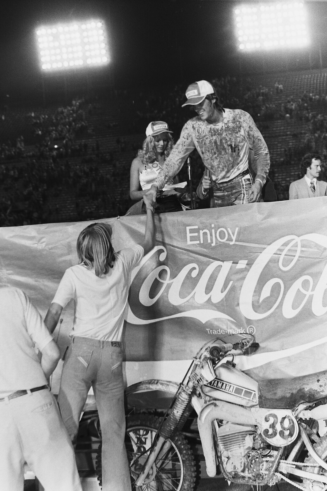 Mike Bell gets a handshake atop the Superbowl of Motocross podium from his brother Scott.