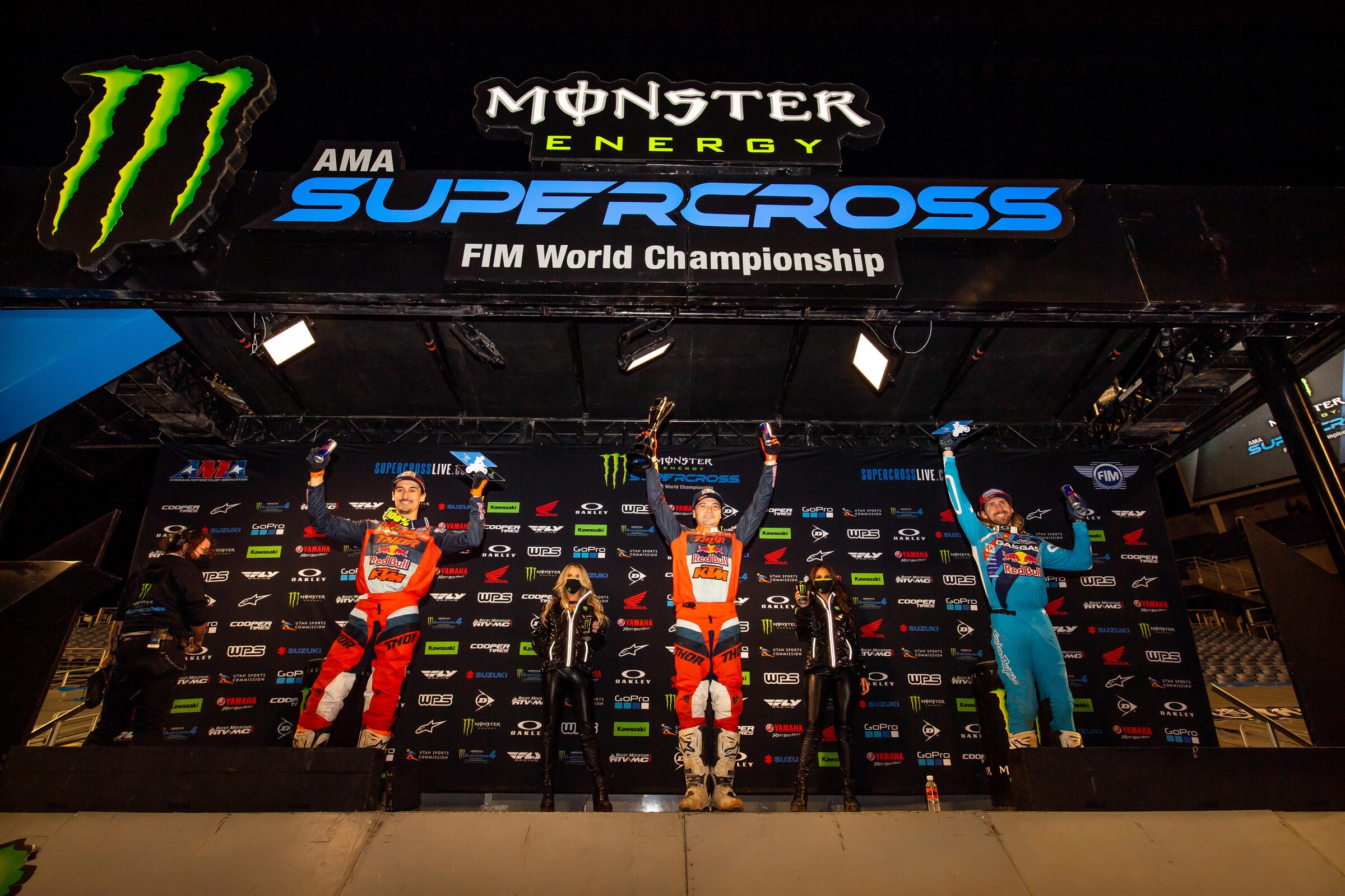 The Orlando 2 Supercross 450SX main event podium: Cooper Webb (center, first), Marvin Musquin (left, second), and Justin Barcia (right, third).