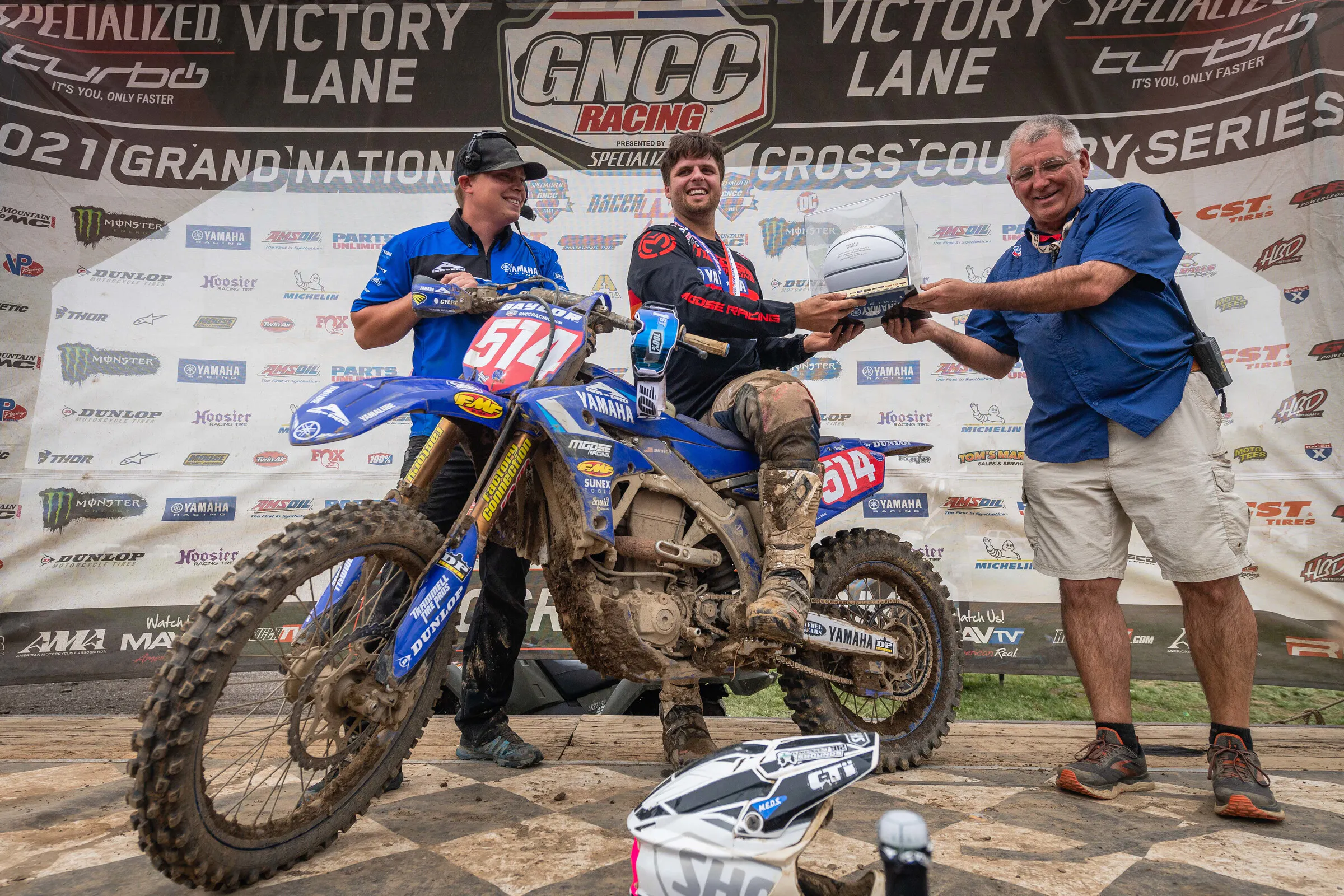 Baylor receiving the Hoosier GNCC Overall trophy from MX Sports' Tim Cotter.