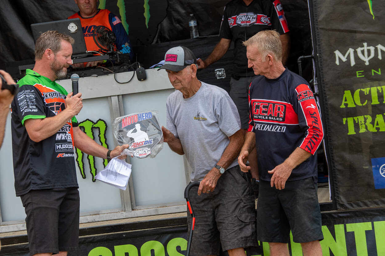 AMSOIL Moto Hero Trevison Brunton (center) with his son, Steve Brunton, being presented the AMSOIL Moto Hero plaque.