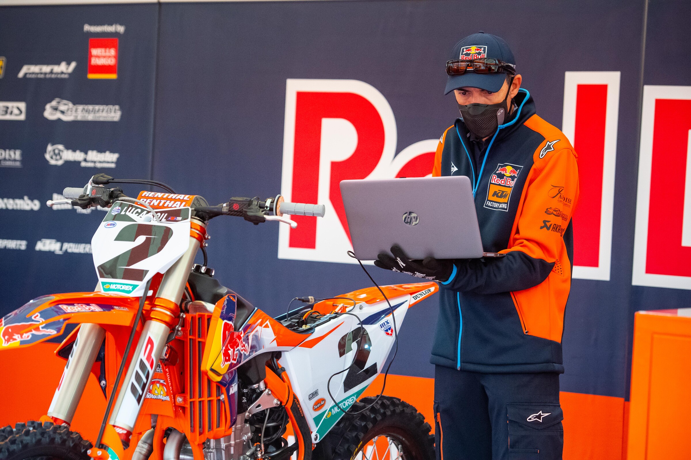 Carlos Rivera checks under Cooper’s hood.