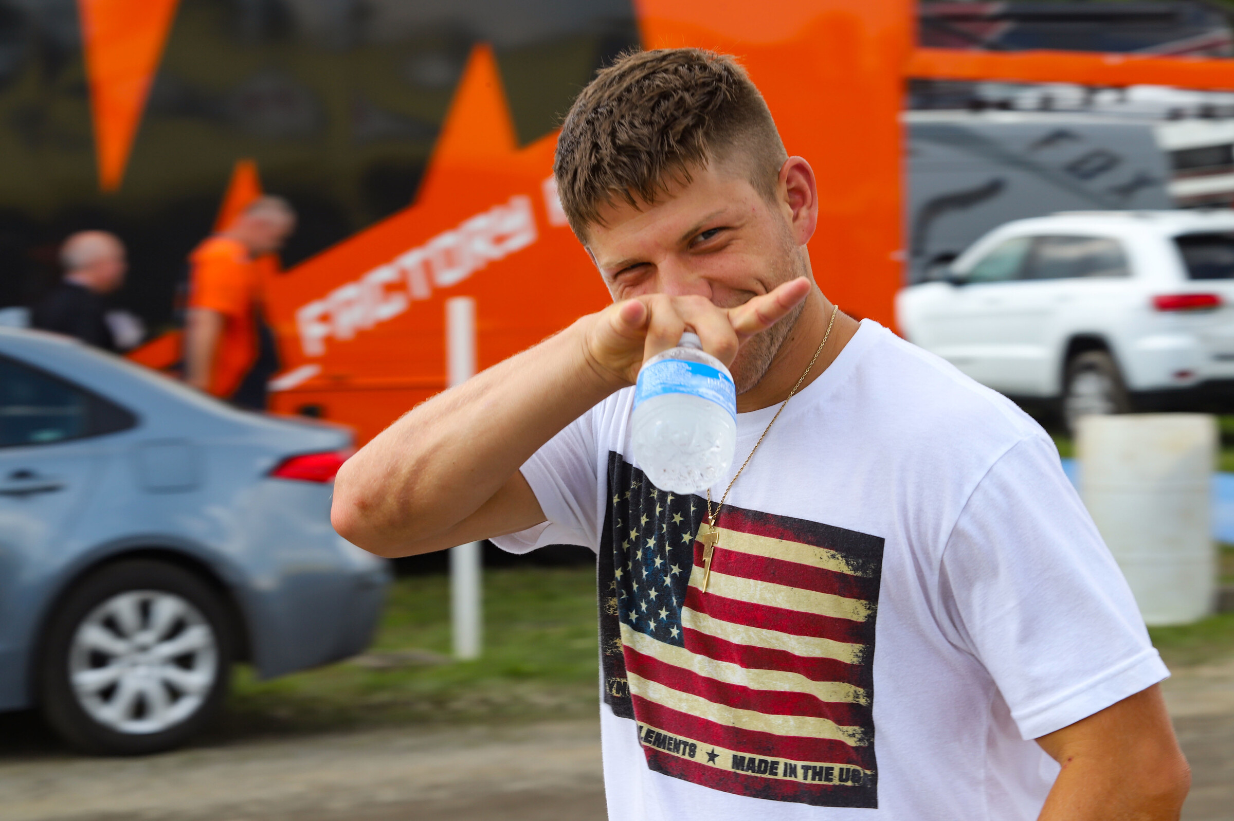 Lane Shaw throws up the Texas horns as he cruises the pits.