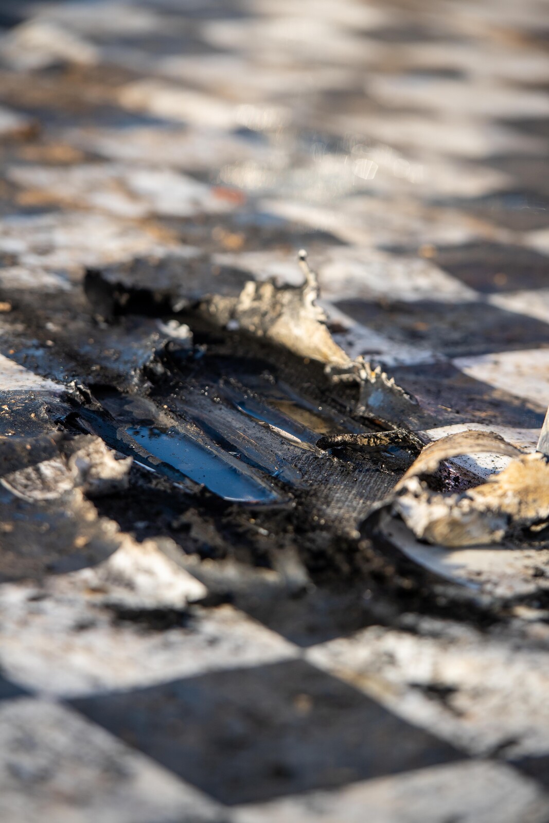 What’s left of the brand-new podium floor after the champs’ burnouts.