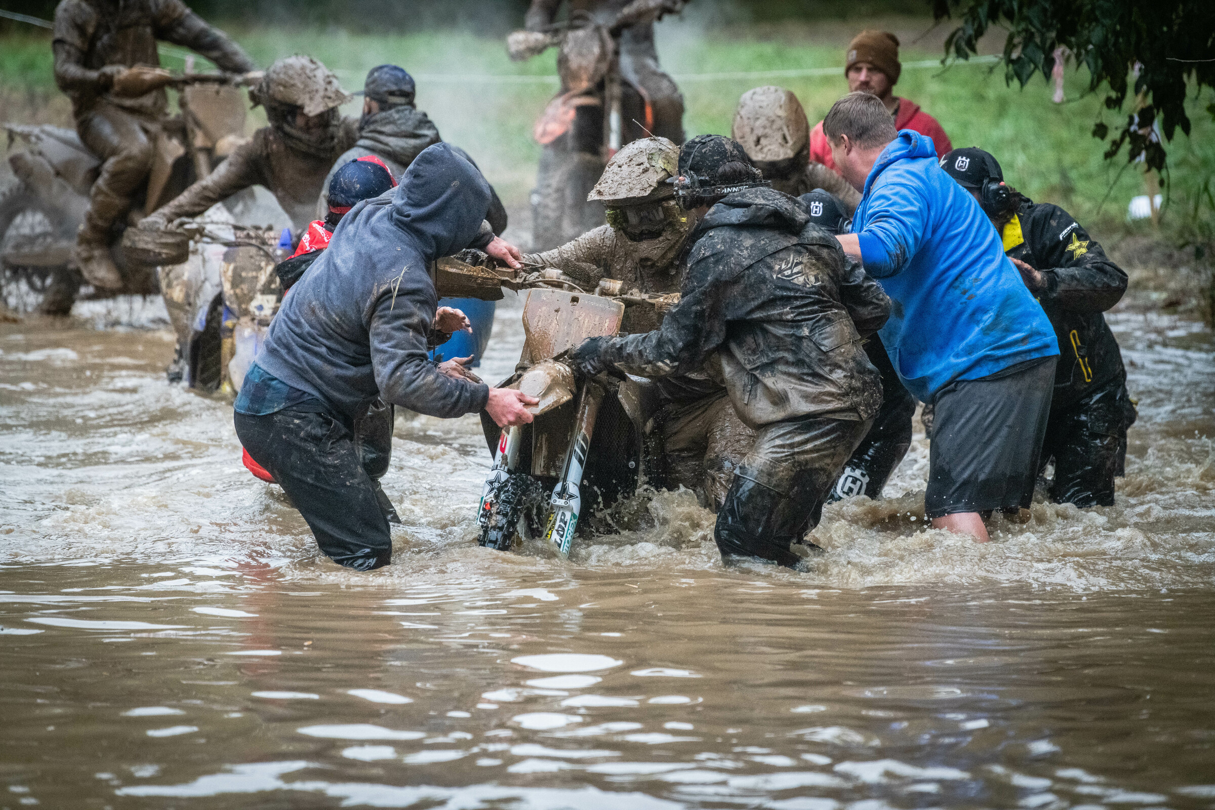 Team members helped pull not only their riders but other riders through the water and slop as well.