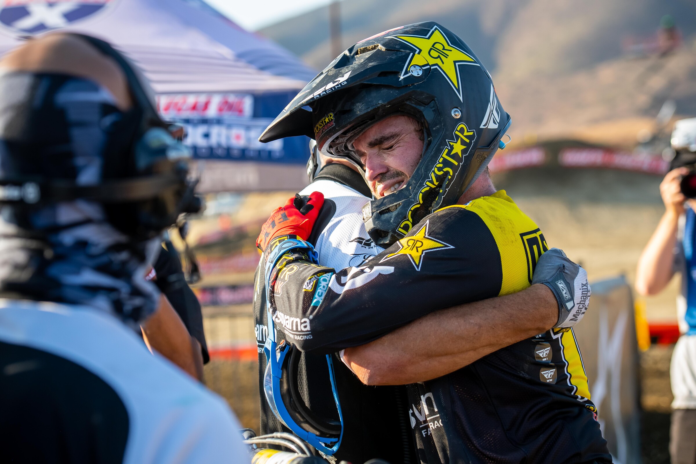 Osborne hugs the Husqvarna staff after claiming his maiden premier class title.