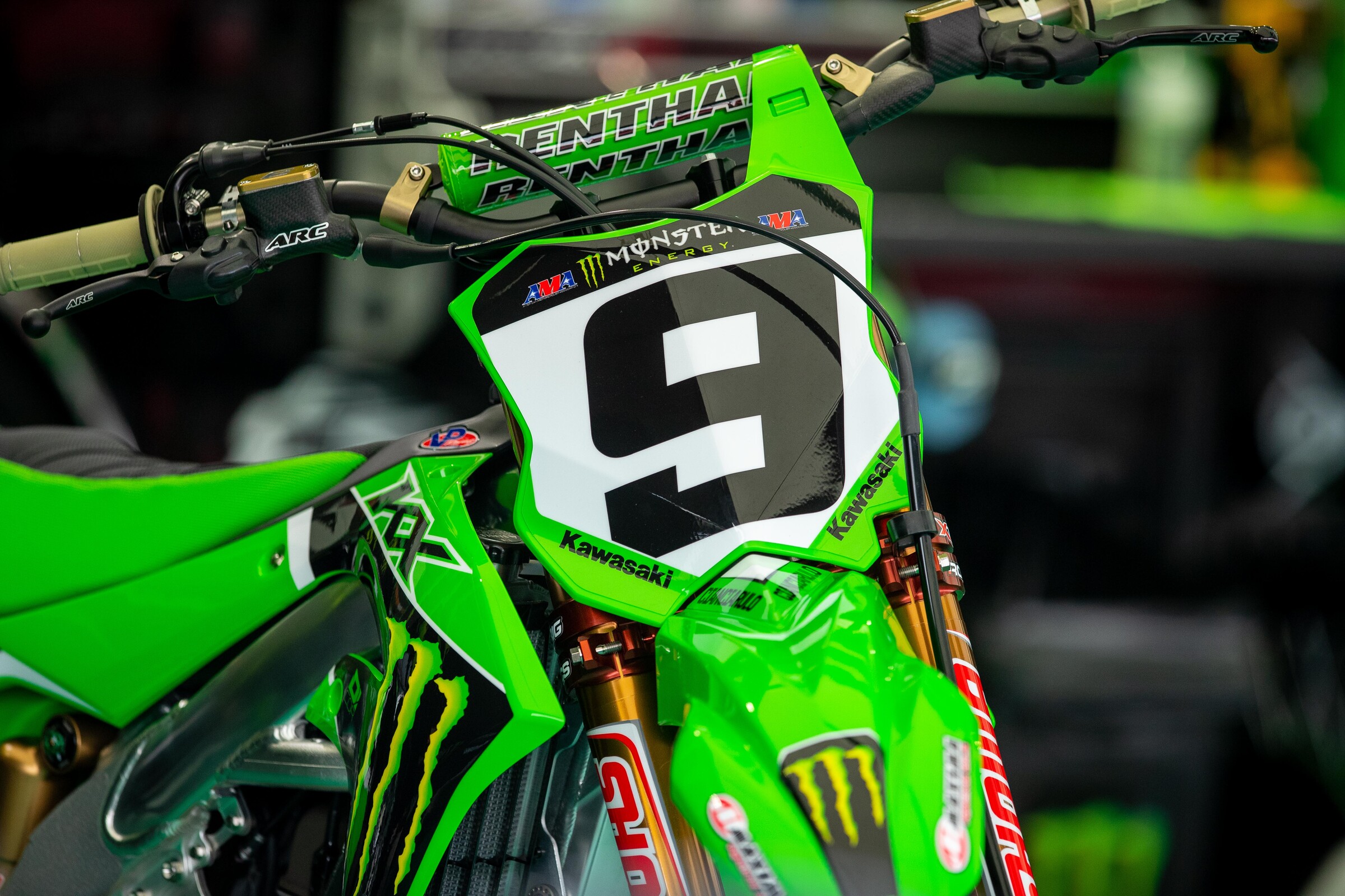 Adam Cianciarulo's Kawasaki KX450 sitting under the Monster Energy Kawasaki team tent.