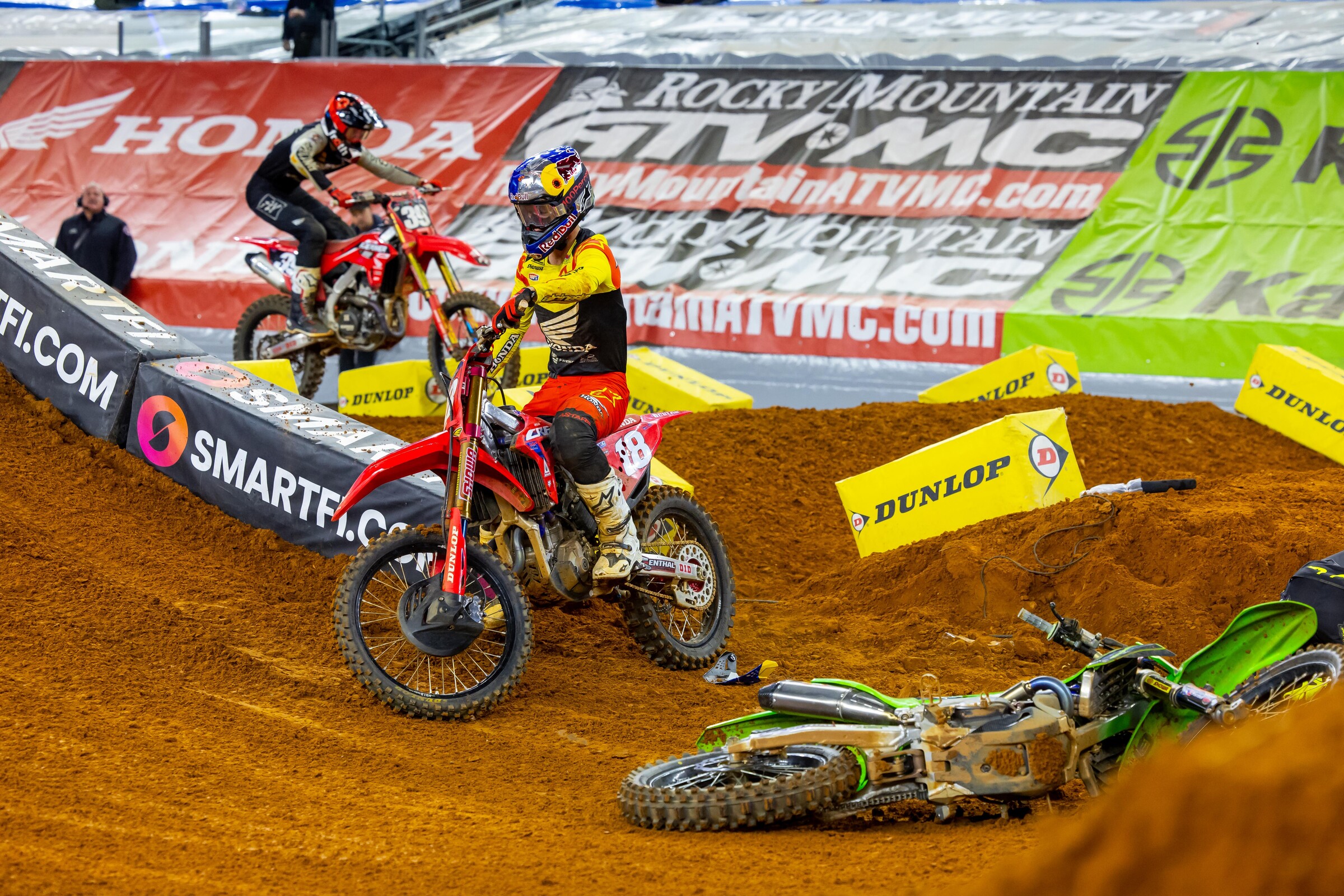 Jett Lawrence remounts after crashing with Austin Forkner over the finish line jump.