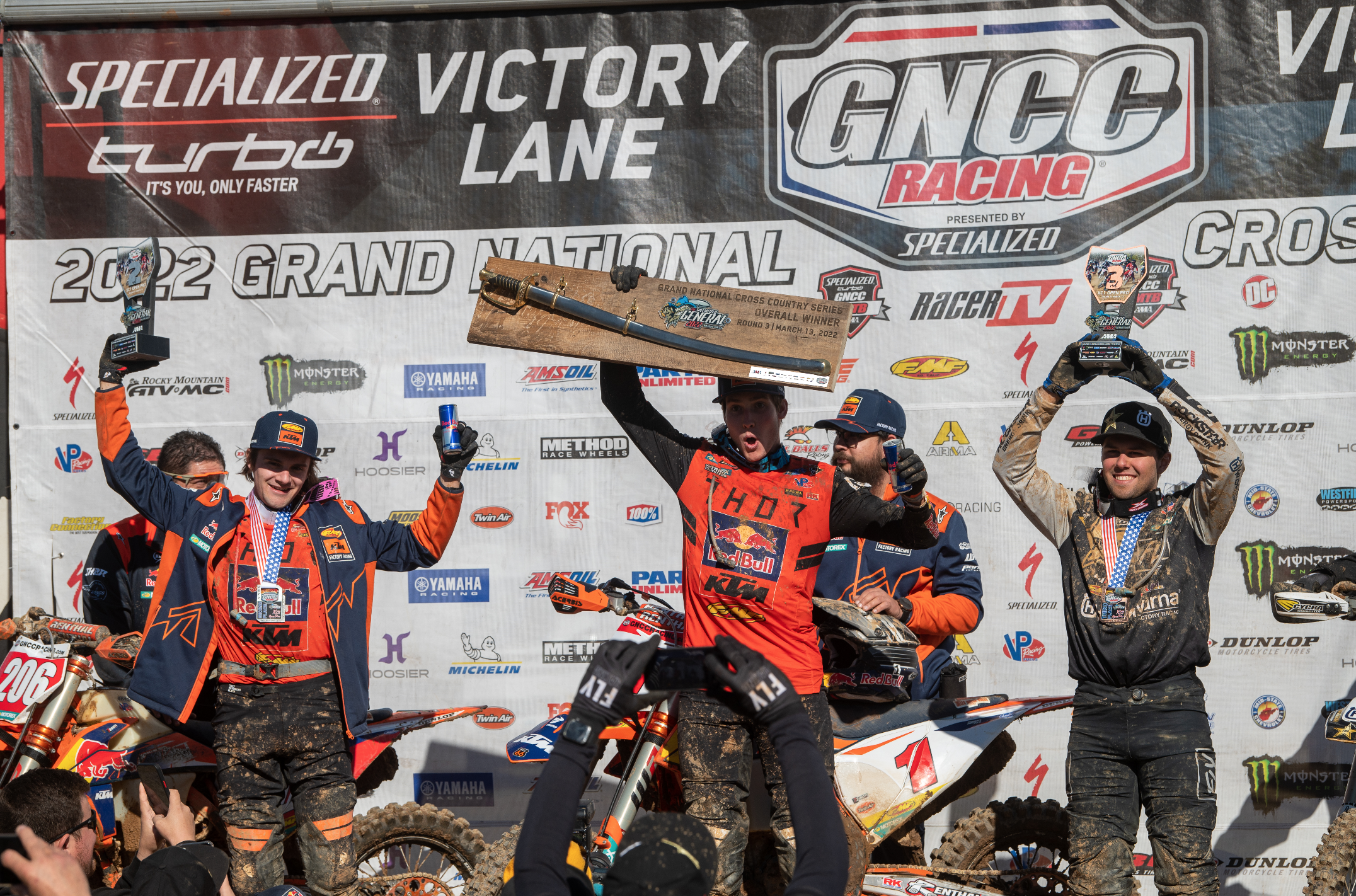 The overall podium at The General GNCC: Ben Kelly (center, first), Josh Toth (left, second), and Craig Delong (right, third).
