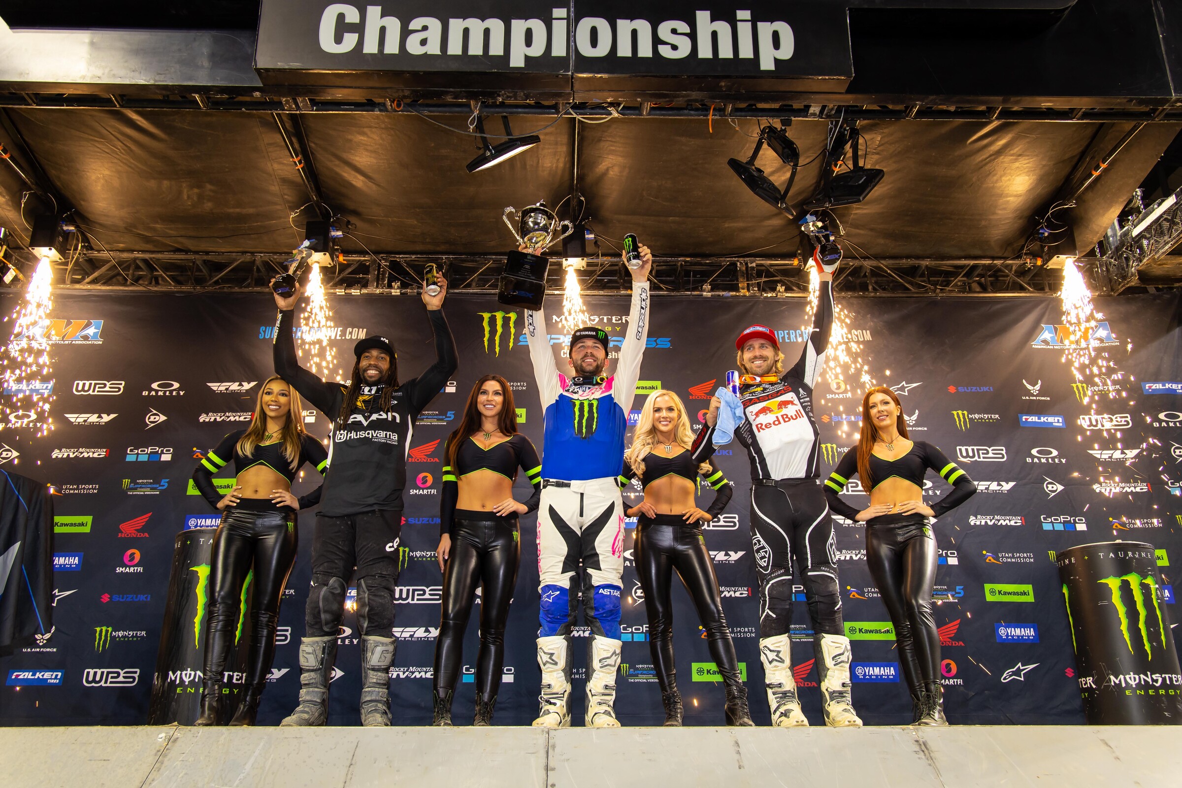 The 2022 Detroit Supercross 450SX podium: Eli Tomac (center, first), Malcolm Stewart (left, second), and Justin Barcia (right, third).