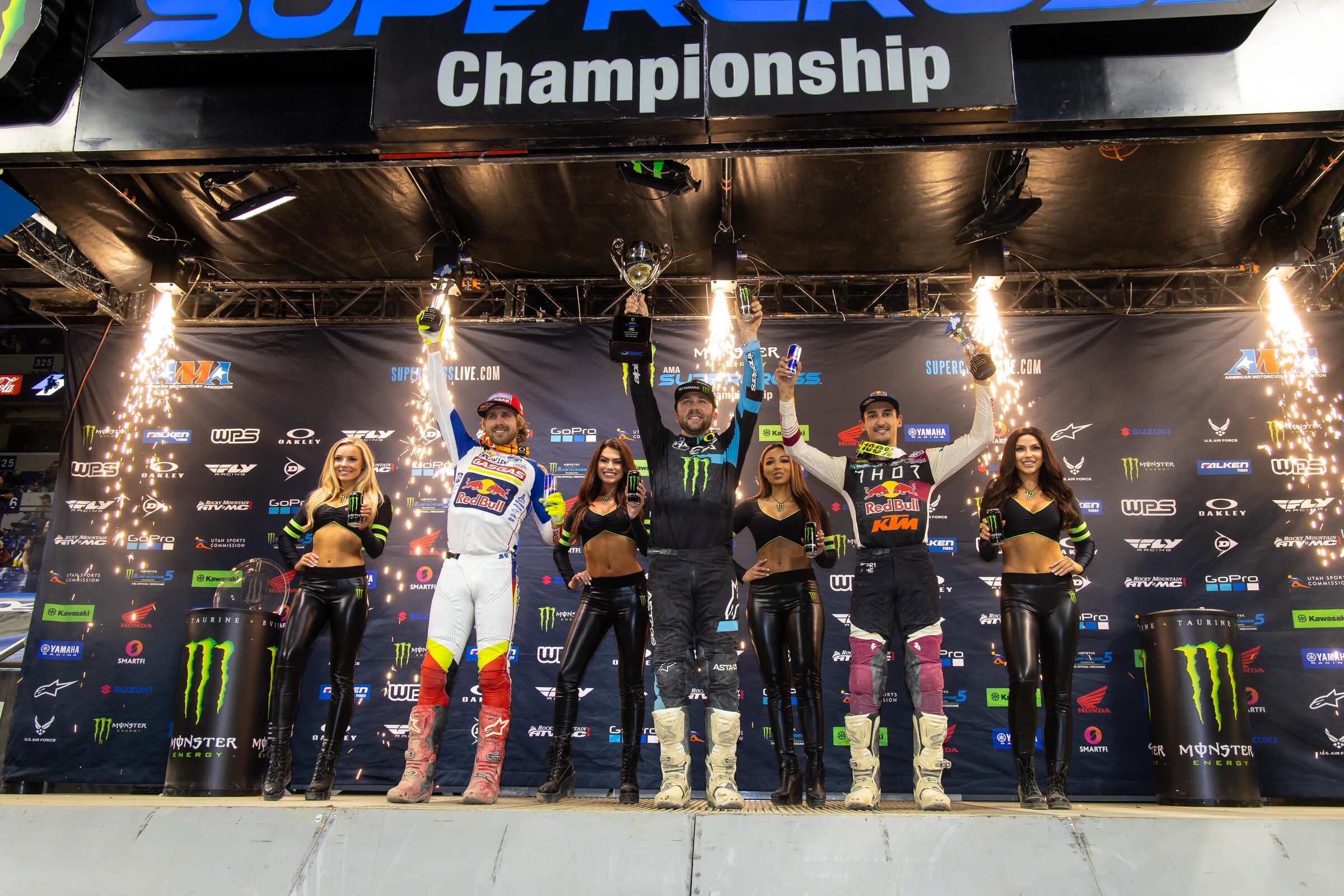 The 2022 Indianapolis Supercross 450SX podium: Eli Tomac (center, first), Justin Barcia (left, second), and Marvin Musquin (right, third).
