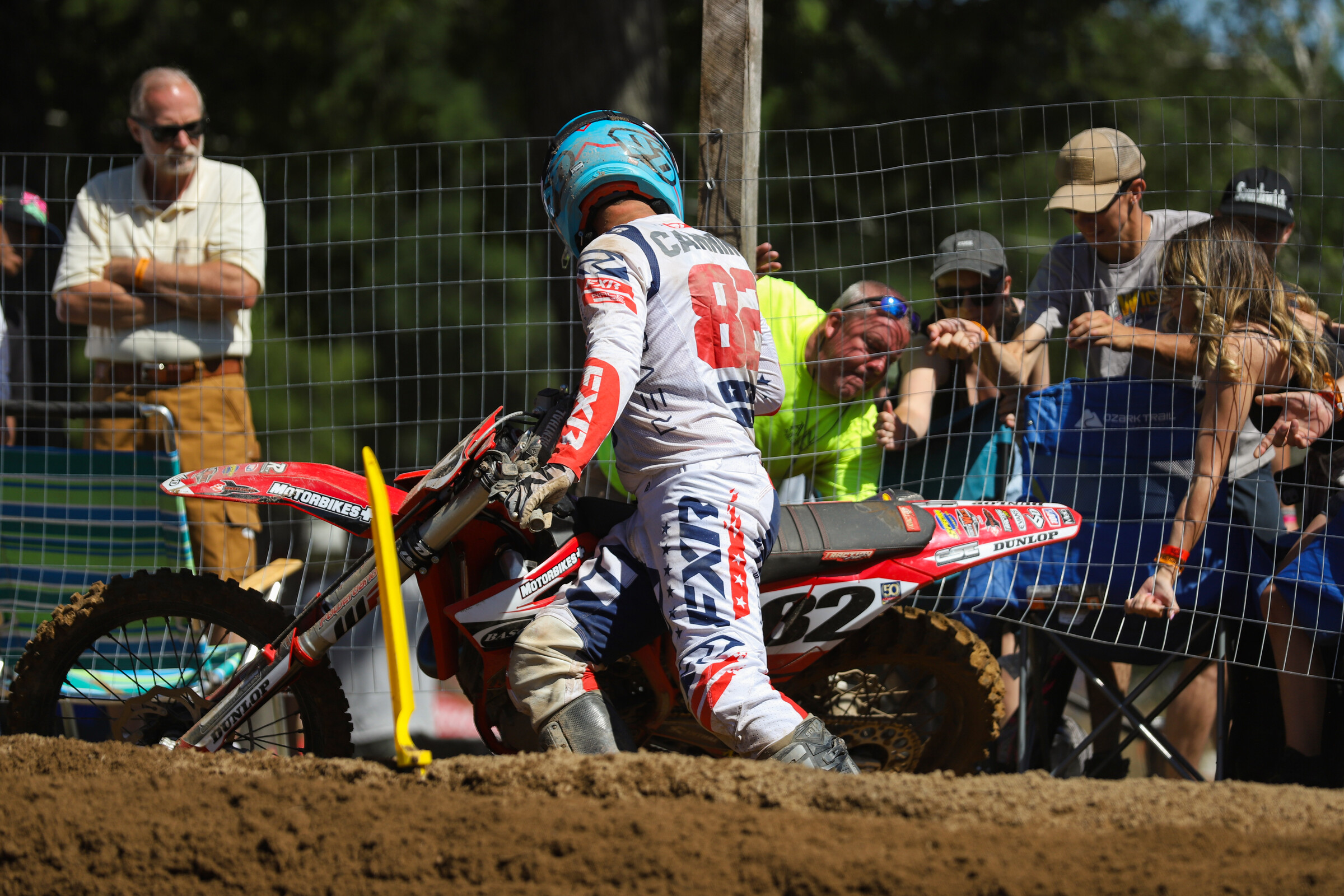 The locals helping their guy get unstuck from the fence.