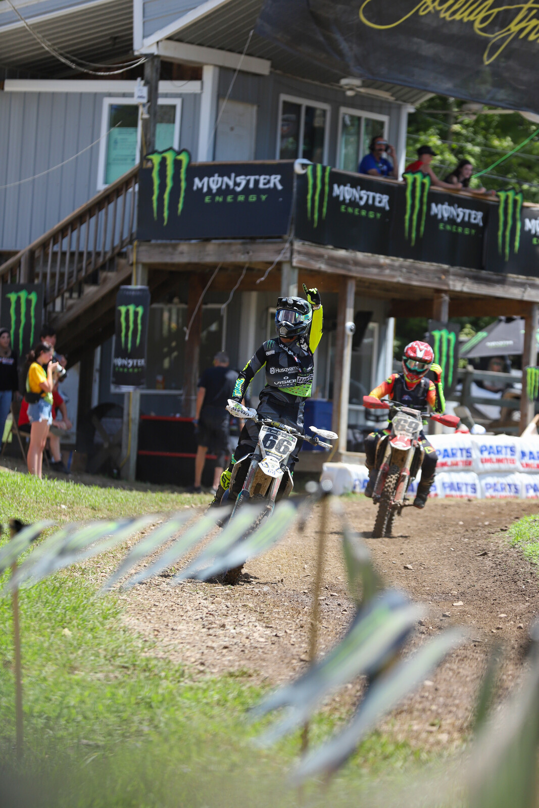Casey Cochran pointing to his family after winning the final Schoolboy 1 (12-17) B/C moto, which gave him the overall title.