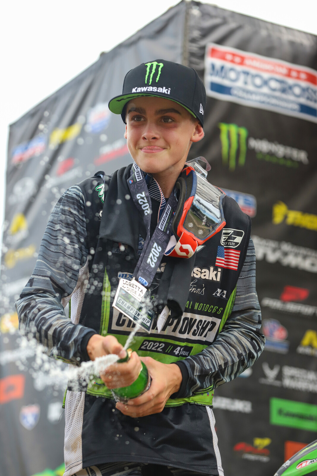 Caden Dudney spraying champagne after his Mini Sr 1 (12-14) title on Friday.