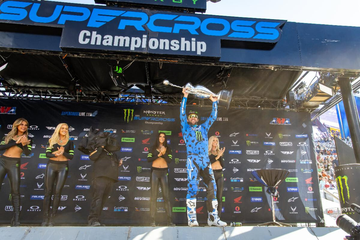 Eli Tomac hoisting the Monster Energy AMA Supercross Championship trophy after clinching his second world championship in Denver at Empower Field at Mile High Stadium.