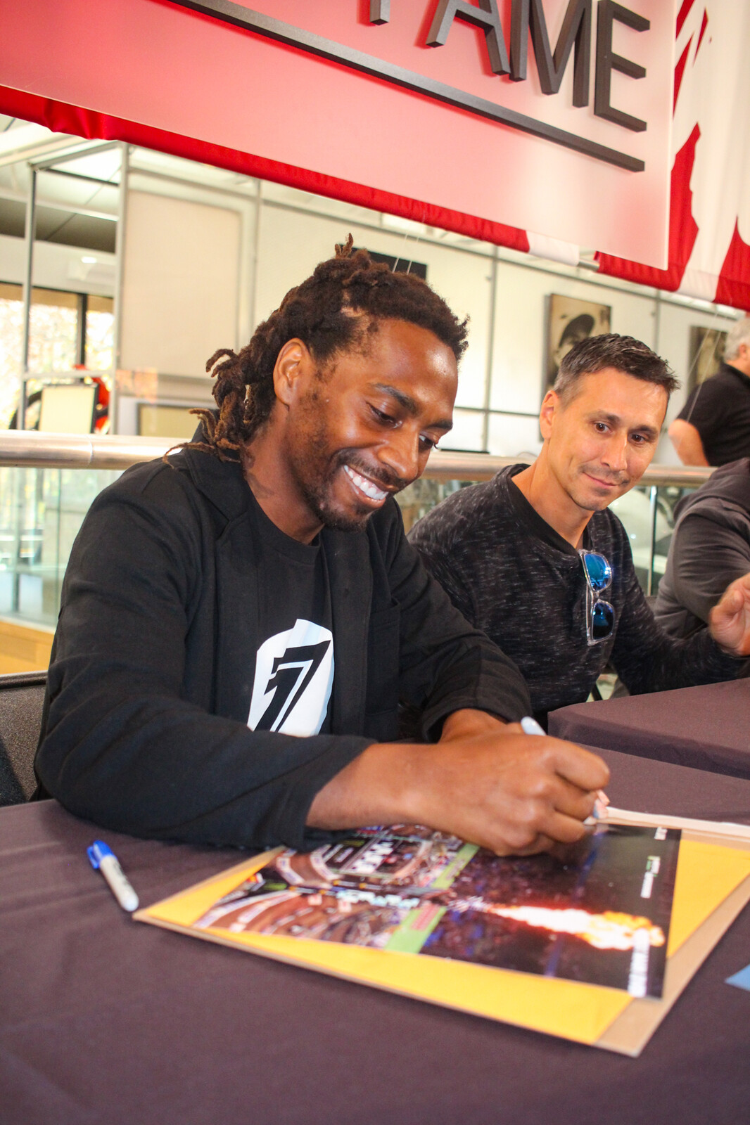 Stewart signing autographs for fans.