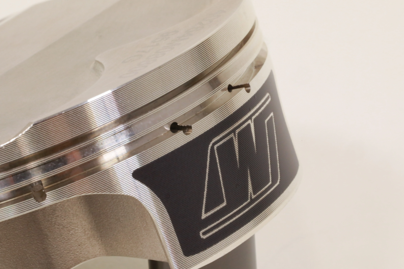 Accumulator groove reduces pressure buildup below compression ring to greatly reduce the risk of ring flutter and aid in consistent ring seal, compression, and power.