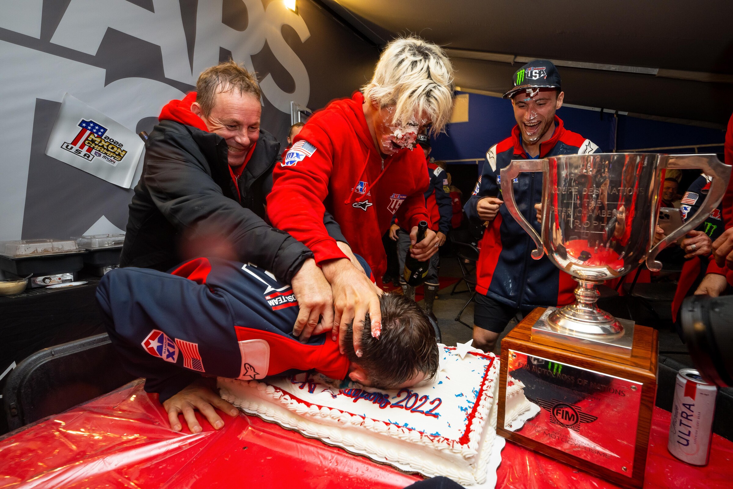 Eli Tomac gets his face pushed into the Team USA cake following a USA victory at the 2022 Monster Energy FIM Motocross of Nations.