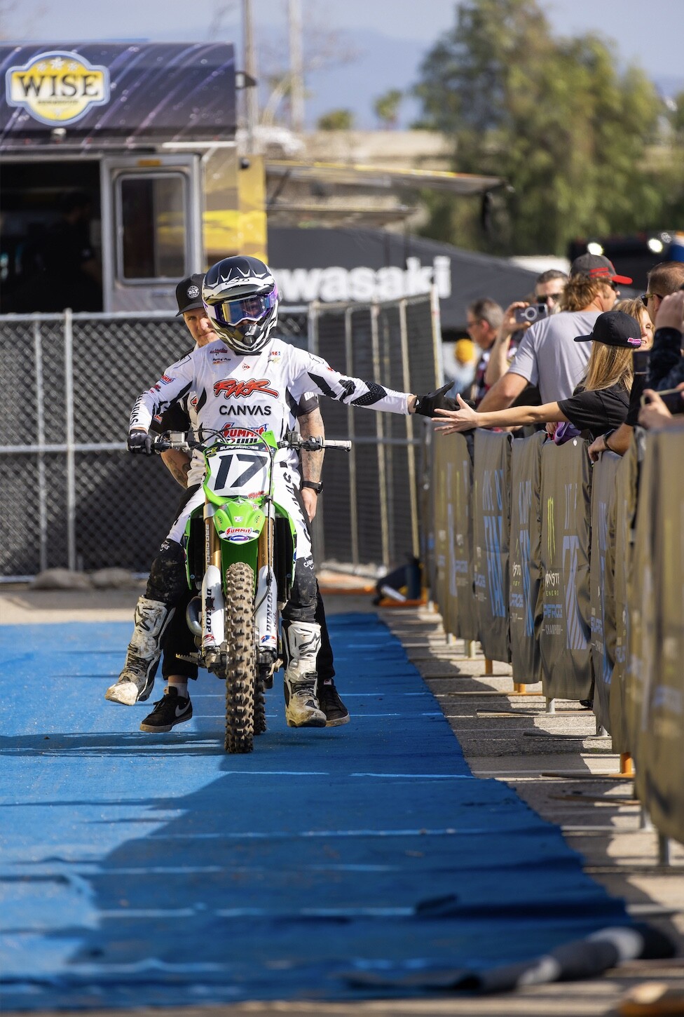 Savatgy and mechanic, former racer Ben LaMay say hi to the fans. 
