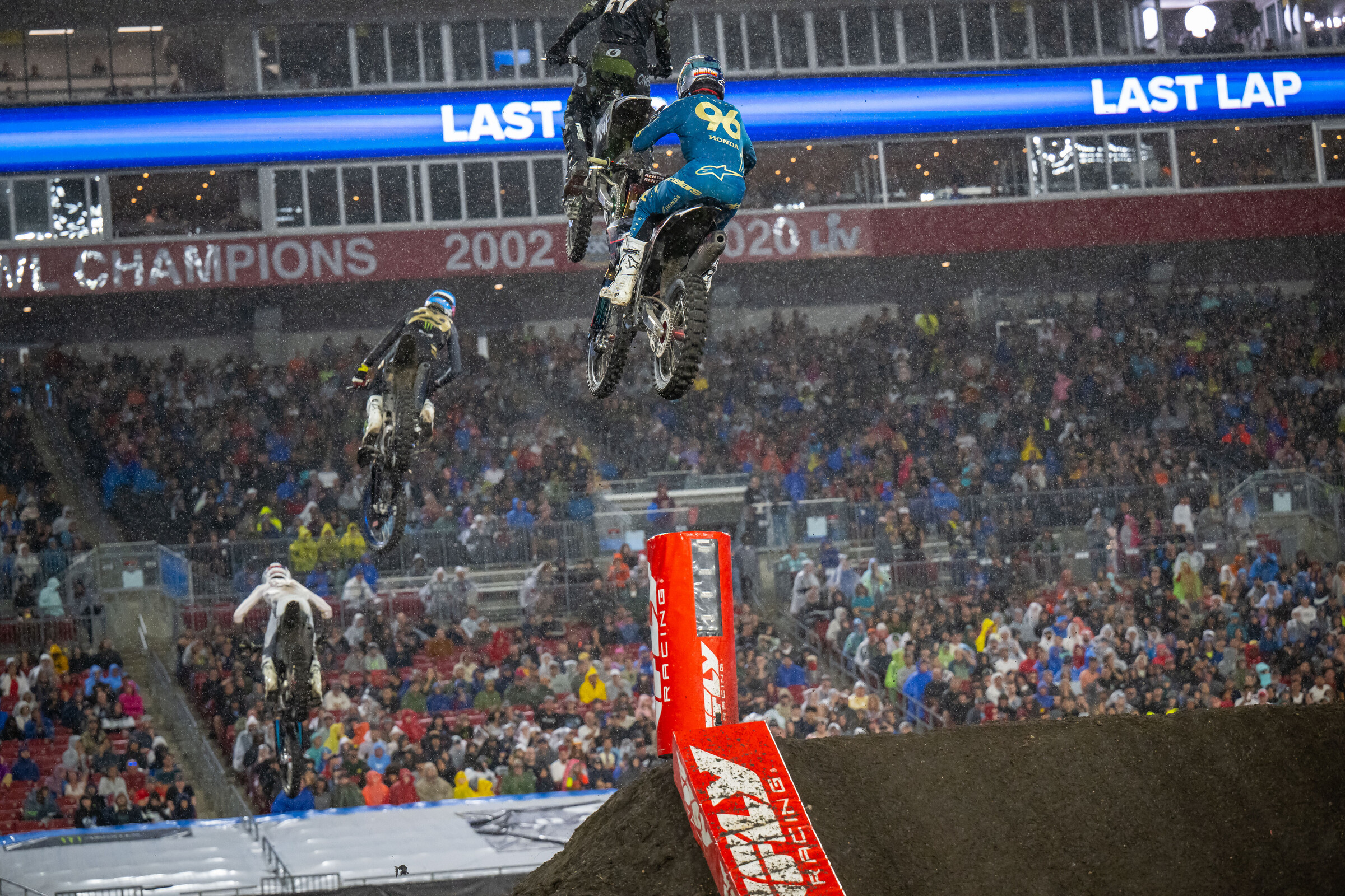 Hunter Lawrence closing in on Nate Thrasher mixed together with lapped traffic while the rain pours down.