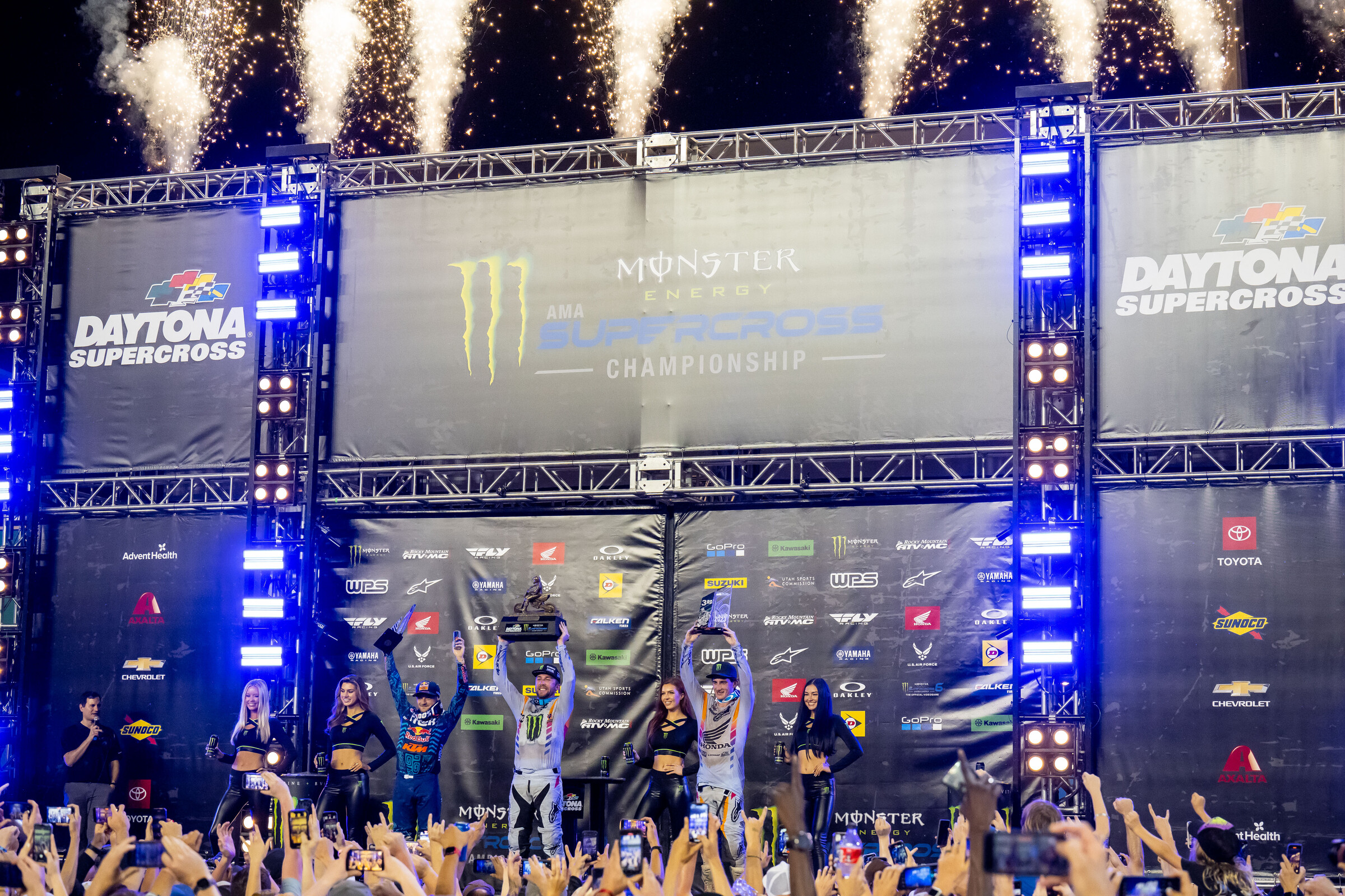 The 2023 Daytona Supercross 450SX main event podium: Eli Tomac (Yamaha), Cooper Webb (KTM, and Chase Sexton (Honda).