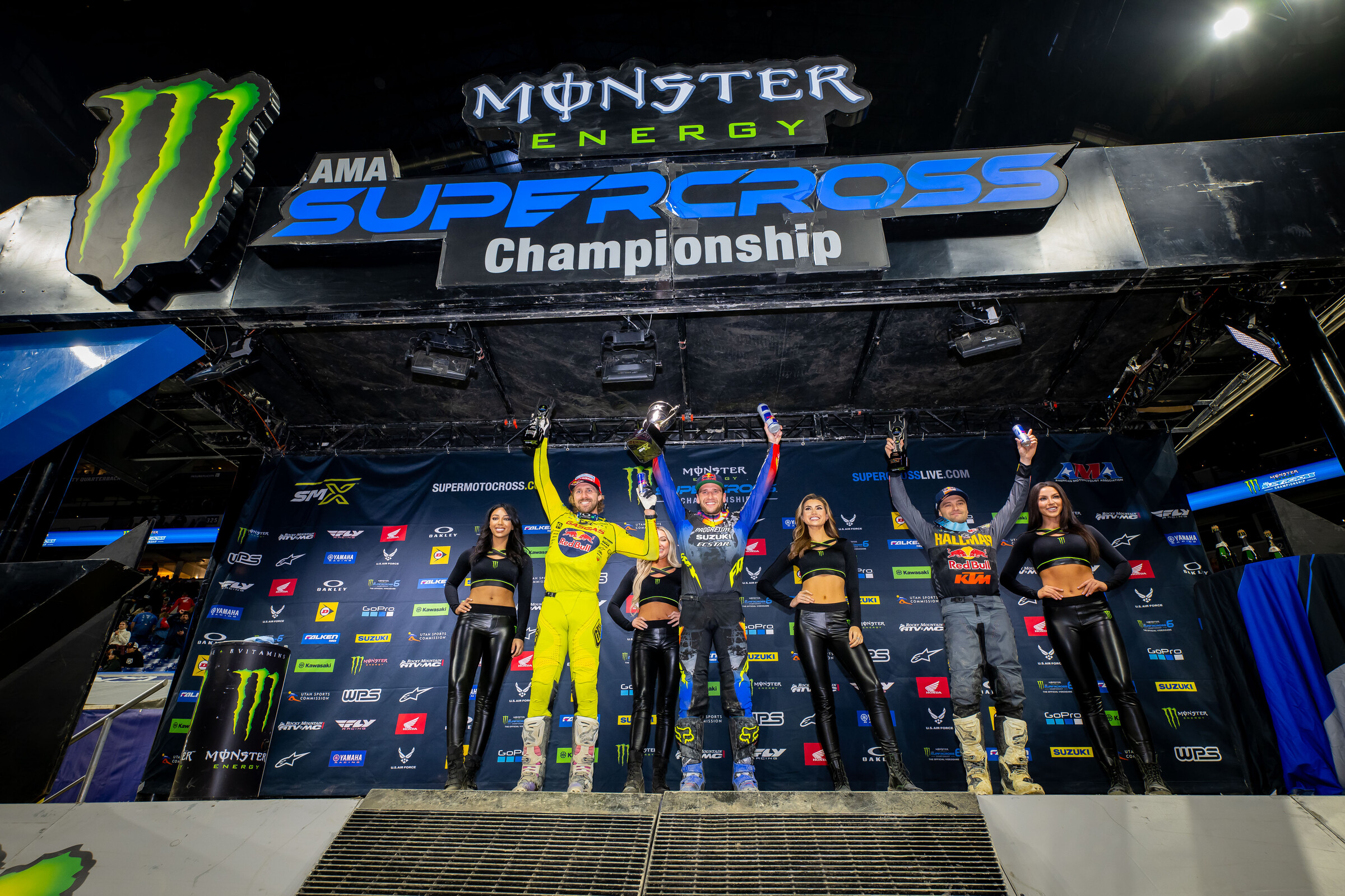 The 2023 Indianapolis Supercross 450SX main event podium: Ken Roczen (Suzuki), Justin Barcia (GasGas), and Cooper Webb (KTM).