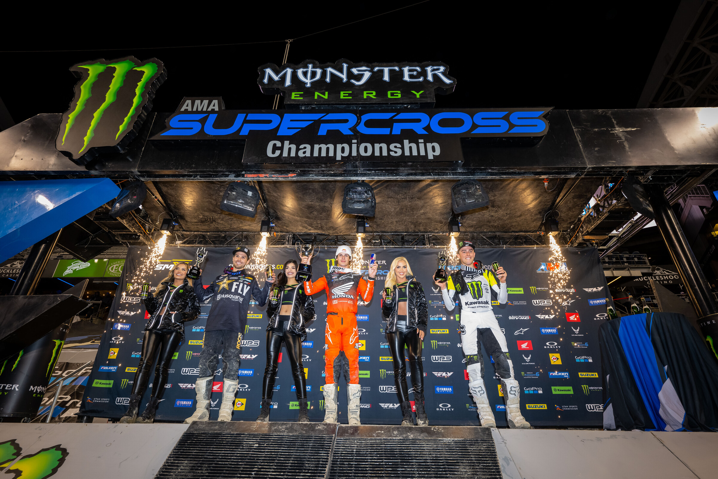 The 2023 Seattle Supercross 250SX main event podium: Jett Lawrence (Honda), RJ Hampshire (Husqvarna), and Cameron McAdoo (Kawasaki).