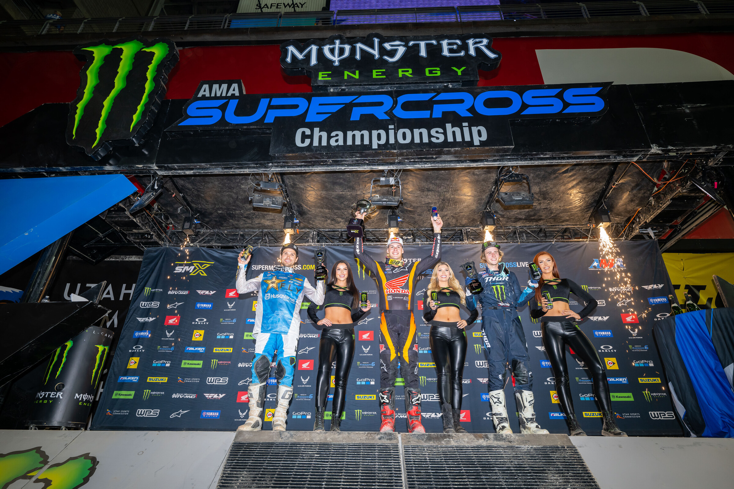 The Glendale Supercross Triple Crown 250SX overall podium: Jett Lawrence (center, first overall), RJ Hampshire (left, second overall), and Levi Kitchen (right, third overall).