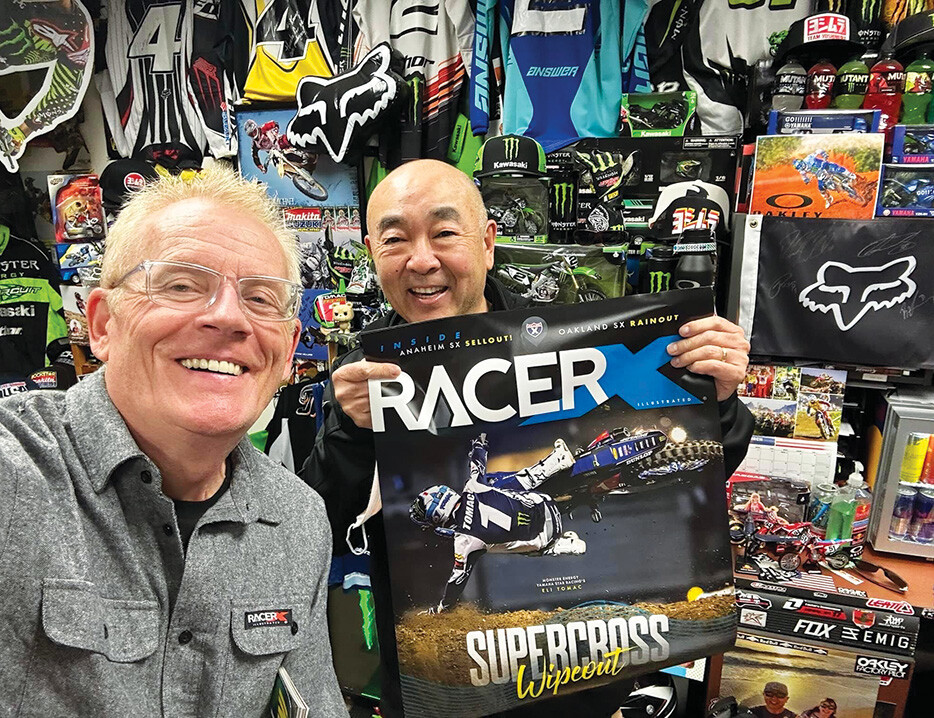Scott Wallenberg hand delivers a Tomac cover poster to New Ray’s Kenny Baba.
