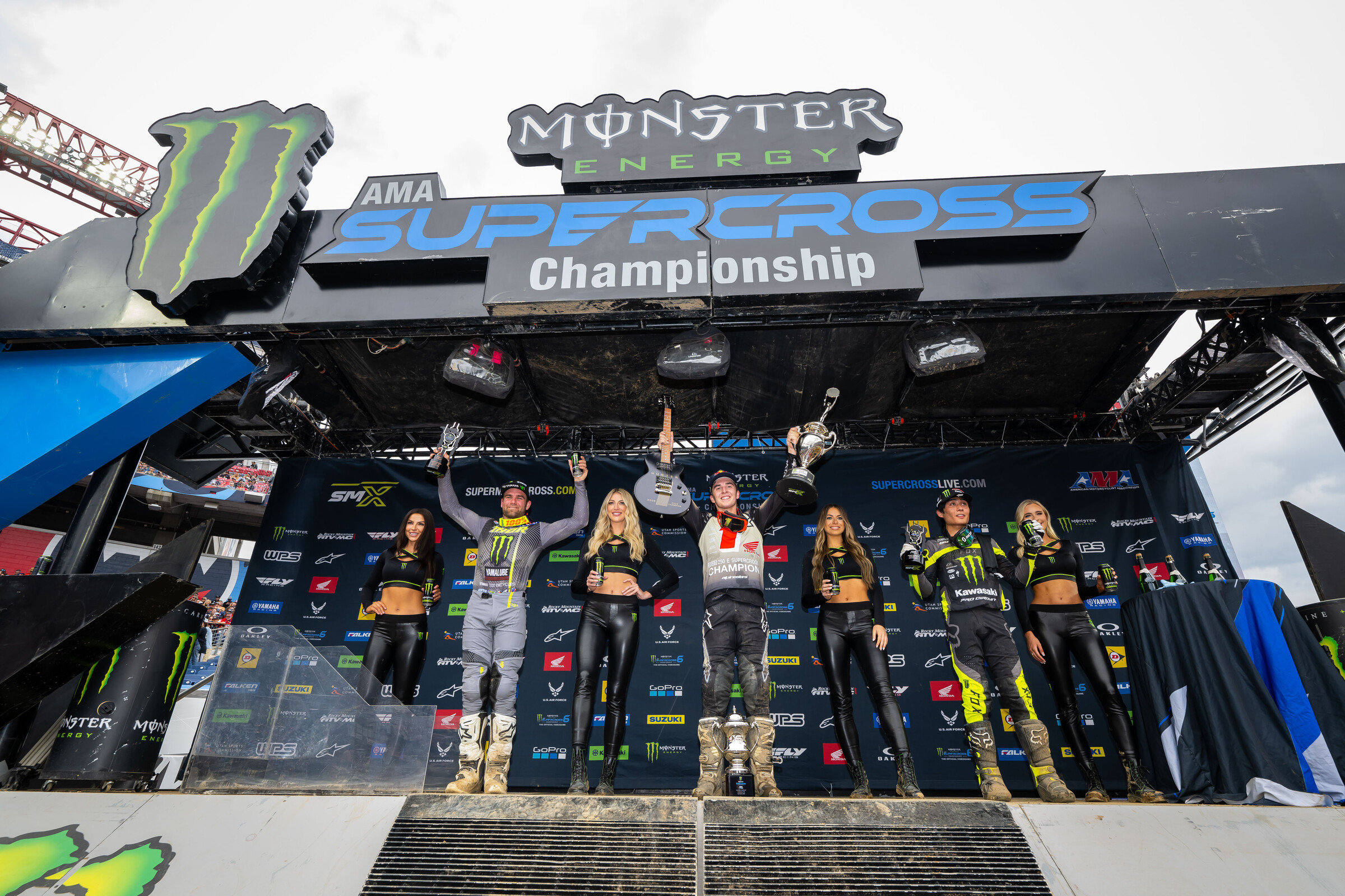 The 2023 Nashville Supercross 250SX main event podium: Hunter Lawrence (center, first), Jo Shimoda (right, second), and Jordon Smith (left, third).