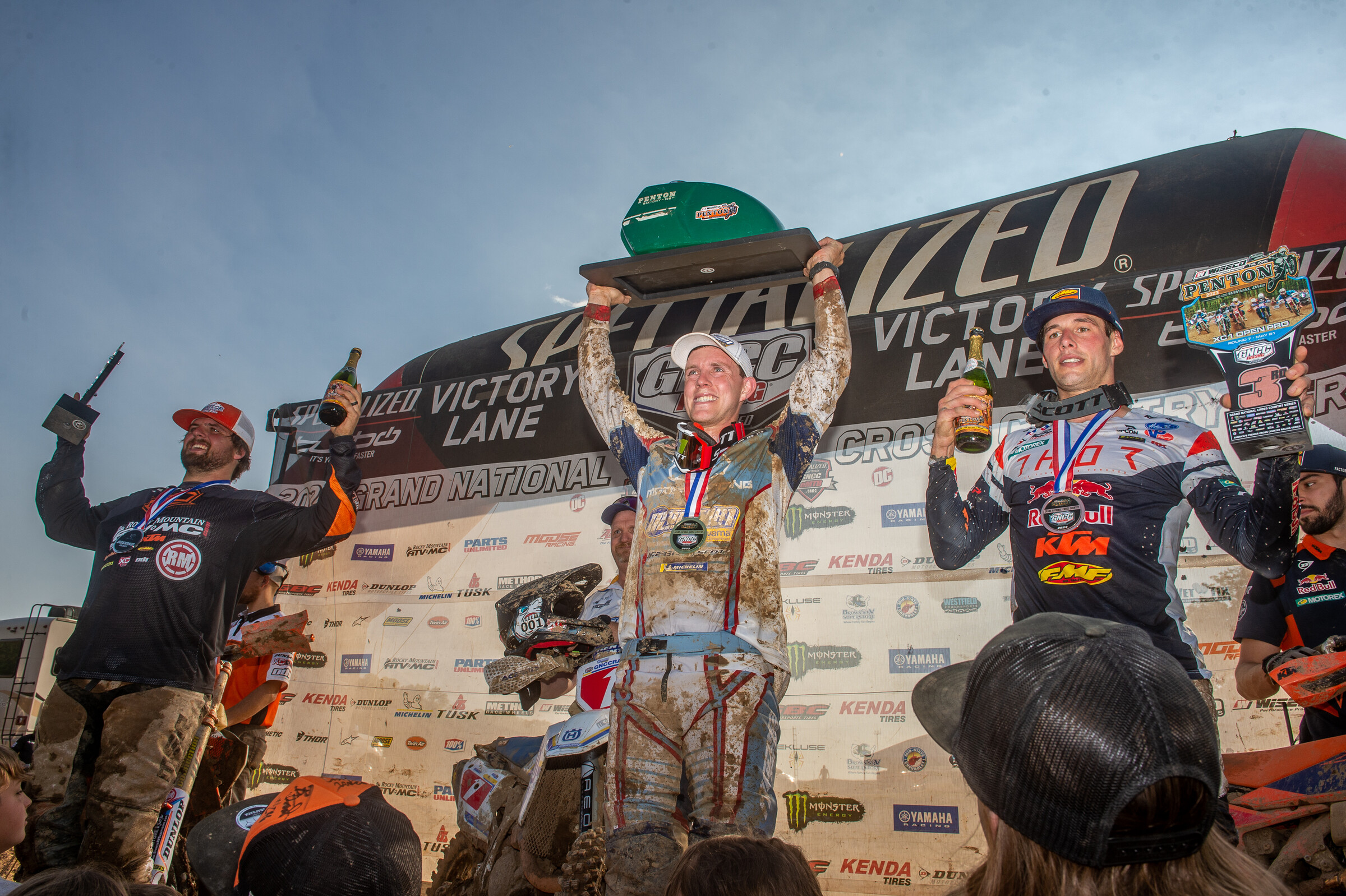 The 2023 John Penton GNCC overall podium: Jordan Ashburn (center, first), Steward Baylor Jr. (left, second), and Johnny Girroir (right, third).