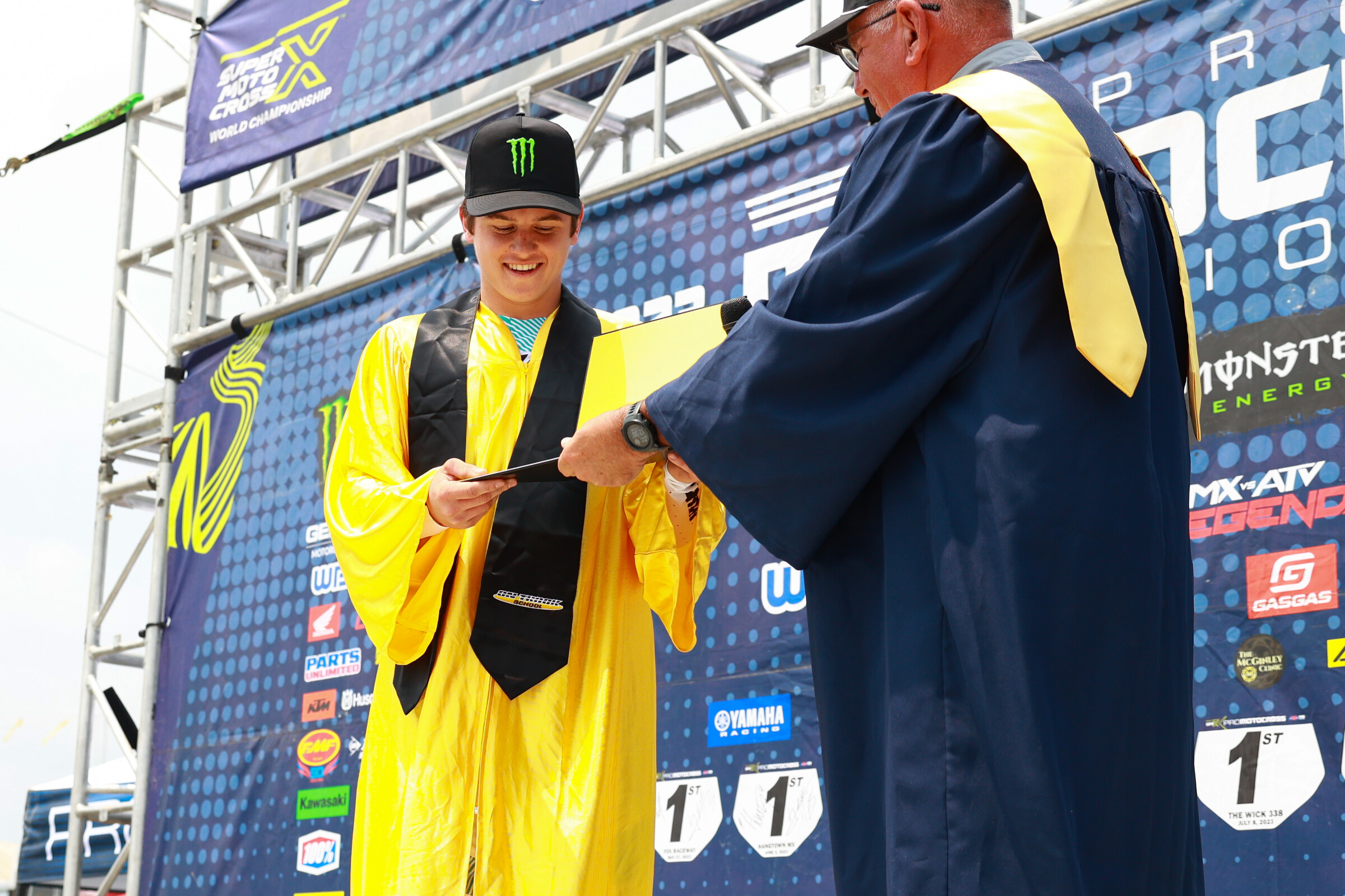 Haiden Deegan receiving his high school diploma from MX Sports' Tim Cotter.