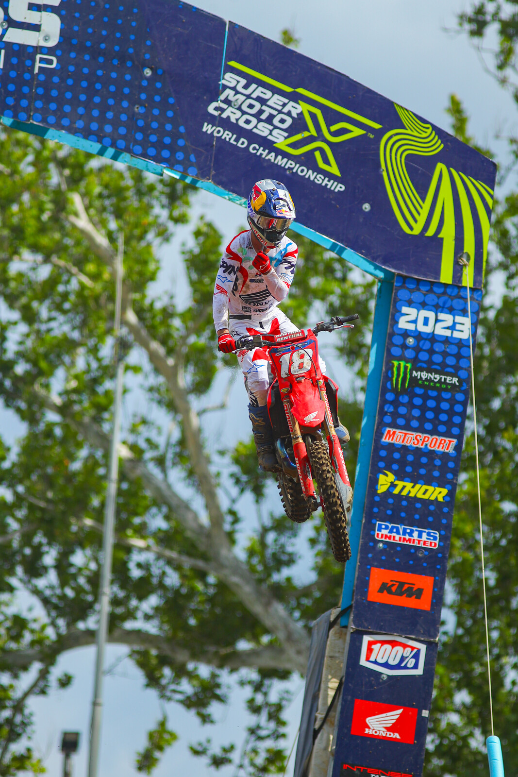 Jett Lawrence rips a tear-off as he takes the checkered flag.