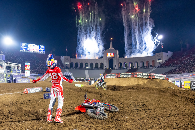 Jett Lawrence celebrates after winning the first-ever SuperMotocross World Championship at the Los Angeles Memorial Coliseum.
