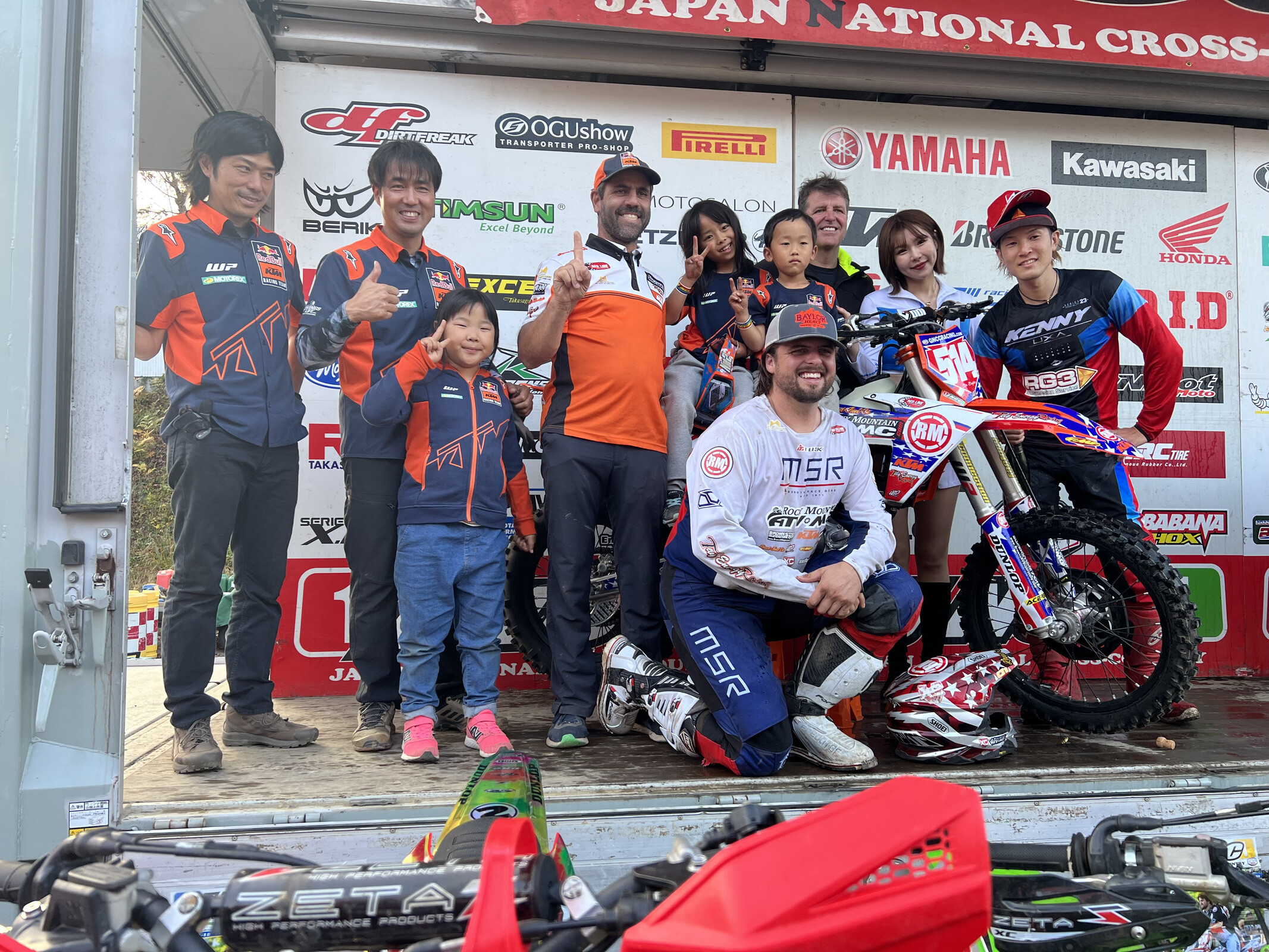 Baylor on the podium after his win with supporters and fans.